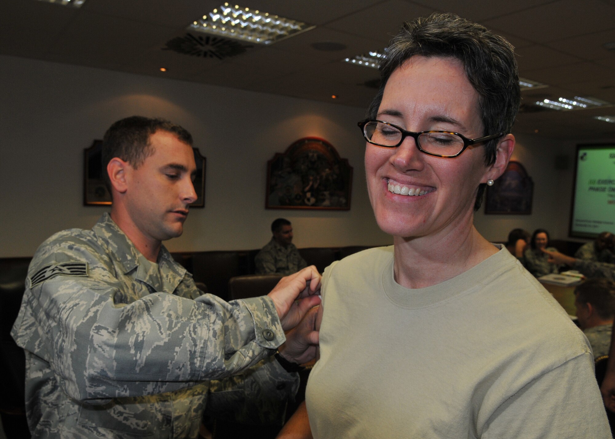SPANGDAHLEM AIR BASE, Germany -- Staff Sgt. Brian Schmit, 52nd Medical Operations Squadron, gives an H1N1 vaccination to Col. Jodine Tooke, 52nd Mission Support Group commander, Nov. 17. Immunization for both seasonal flu and H1N1 is mandatory for all military personnel and is highly recommended for family members. Due to a limited supply of H1N1 vaccines it is not yet known when all servicemembers and their families can receive the vaccine. (U.S. Air Force photo/Airman 1st Class Nick Wilson)