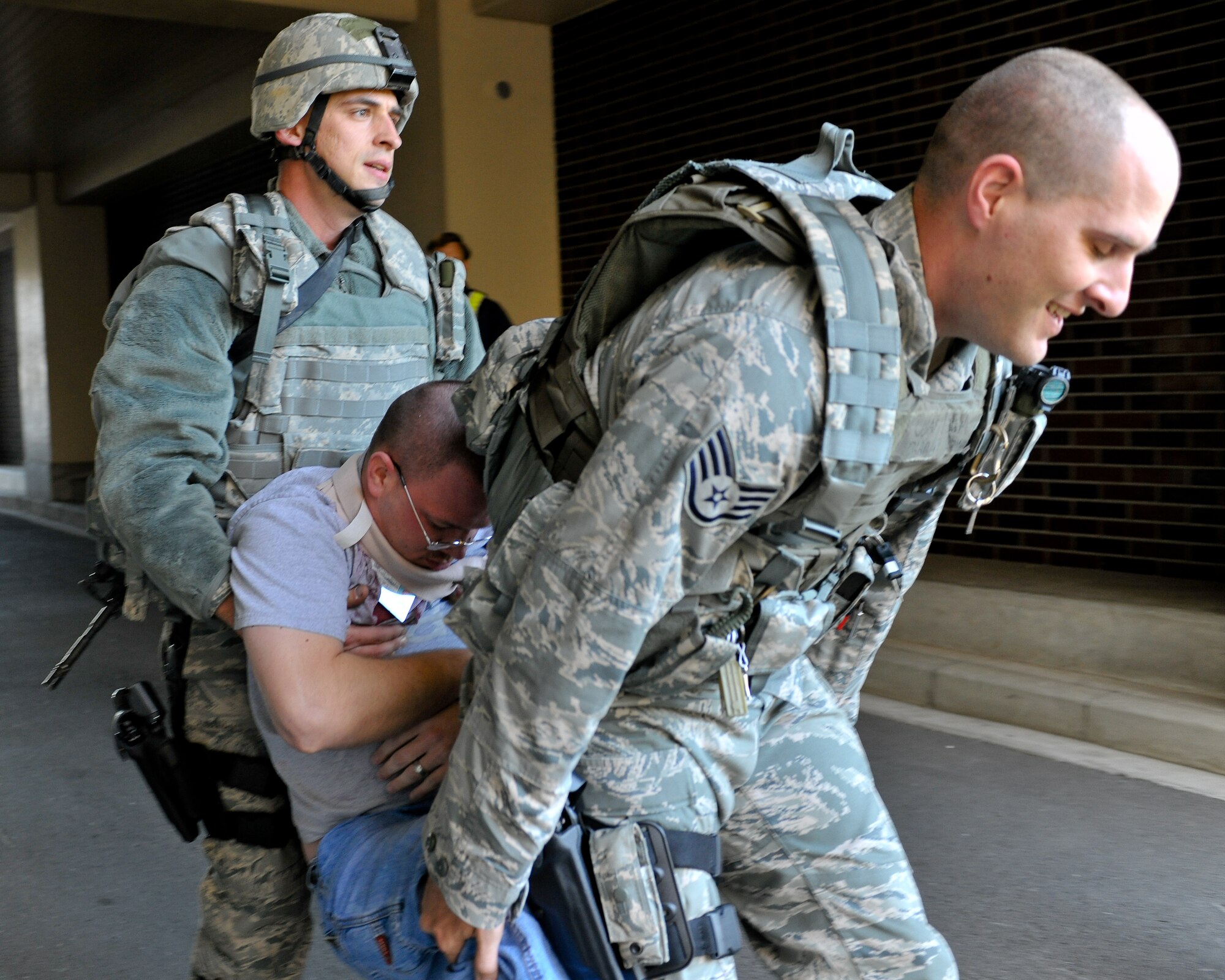 YOKOTA AIR BASE, Japan -- Staff Sgt. Darrin Donovan (right) and Staff Sgt. Arthur Dennis, 374th Security Forces Squadron, transport a victim following a simulated mass casualty exercise Nov. 18 during Phase II Exercise Beverly Morning 10-01. Yokota is conducting an exercise Nov. 18 through Nov. 20 to maintain operational readiness. (U.S. Air Force Photo/Osakabe Yasuo)