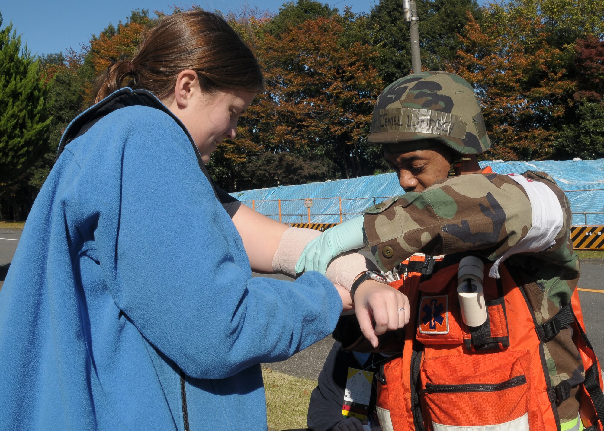 YOKOTA AIR BASE, Japan -- Technical Sgt. Jemel Lindsey, 374th Medical Squadron, gives medical attention to1st Lieutenant Heather Smith, 459th Airlift Maintenance Squadron, during Phase II of Exercise Beverly Morning 10-01. Yokota is conducting an exercise Nov. 18 through Nov. 20 to maintain operational readiness. (U.S. Air Force photo/Airman 1st Class Sean Martin)