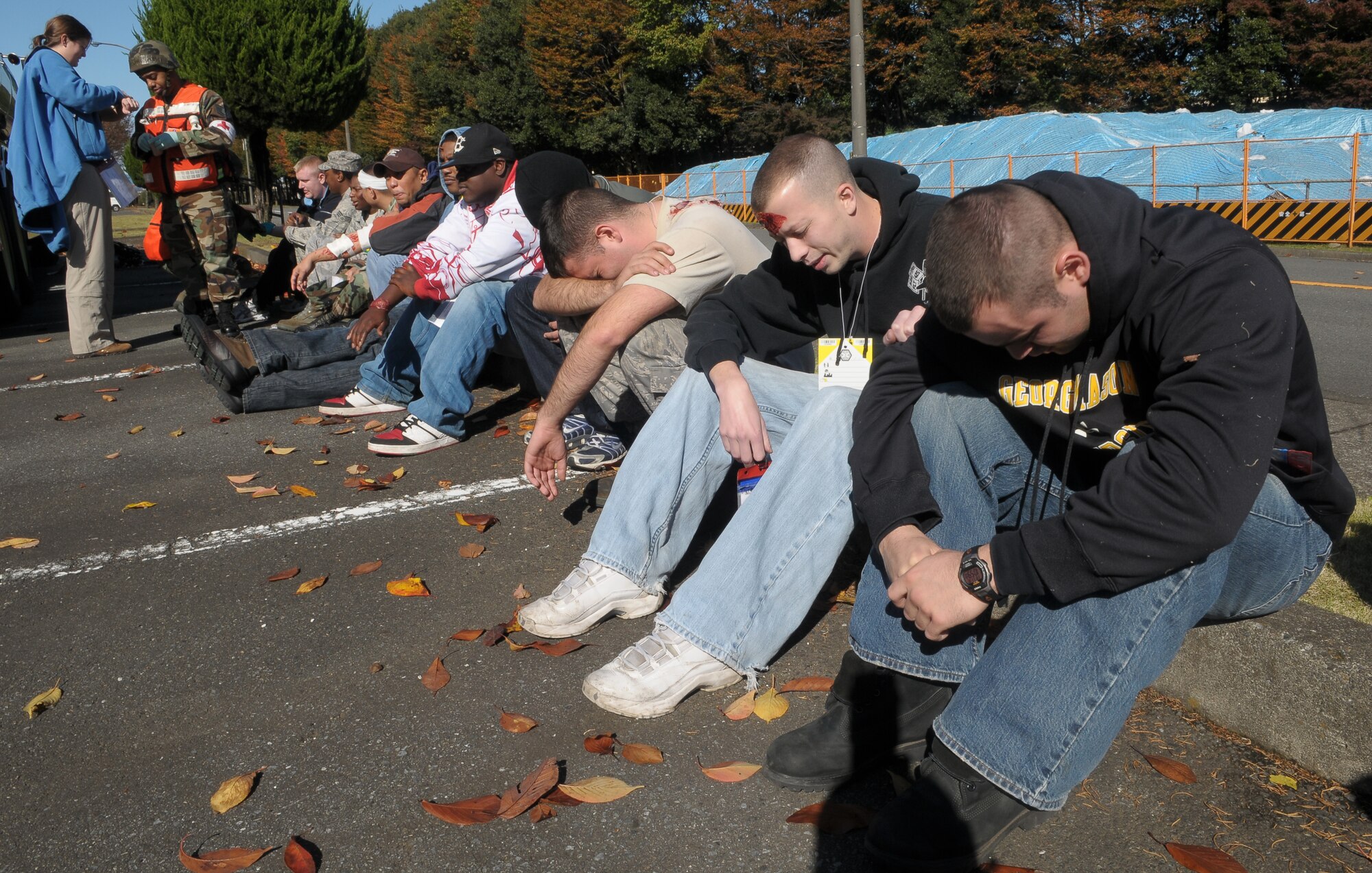 YOKOTA AIR BASE,Japan -- Victims of a simulated bomb attack wait for care during Phase II of Exercise Beverly Morning 10-01. Yokota is conducting an exercise Nov. 18 through Nov. 20 to maintain operational readiness. (U.S. Air Force photo/Airman 1st Class Sean Martin)