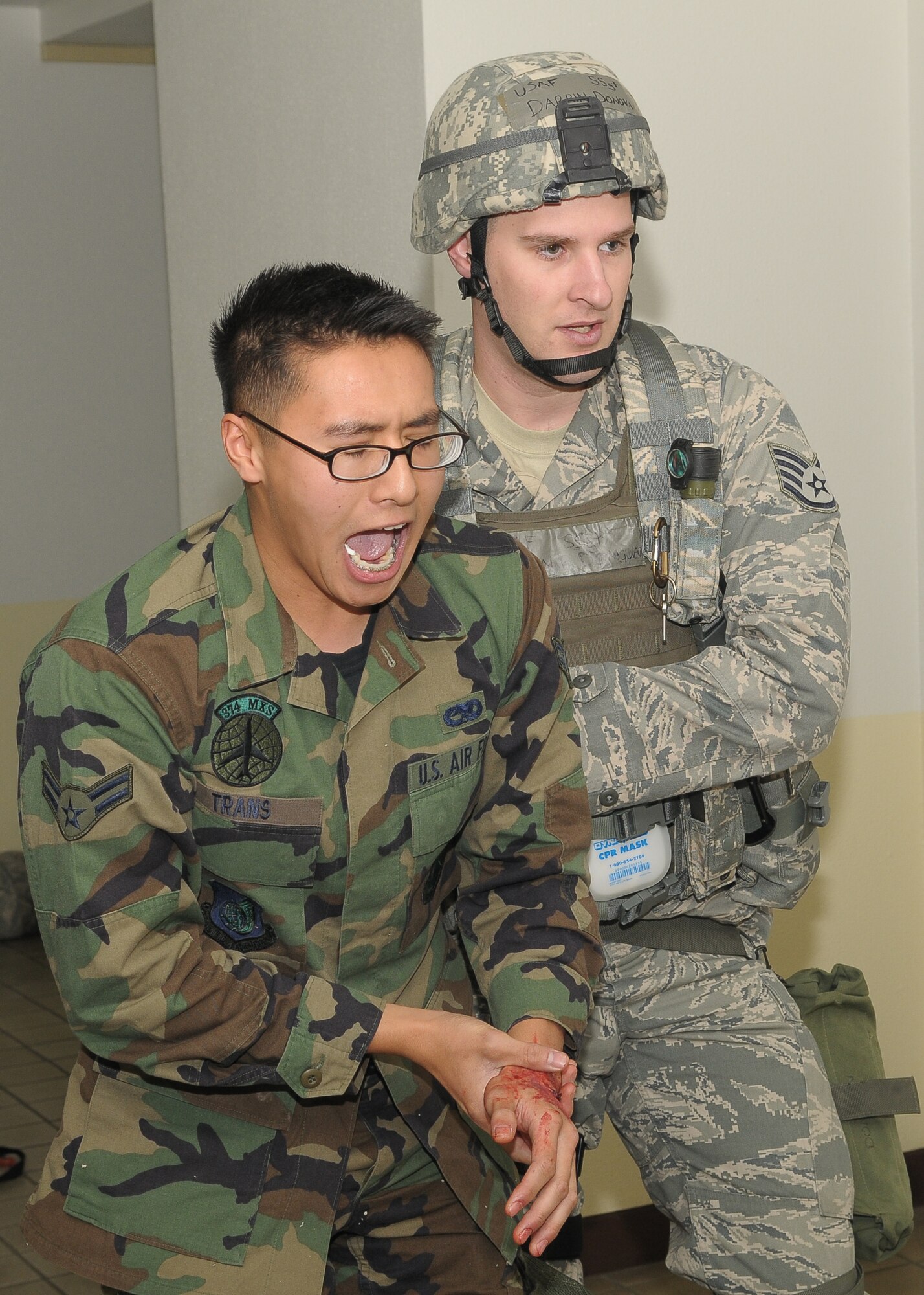 YOKOTA AIR BASE, Japan -- Staff Sgt. Darrin Donavan, 374th Security Forces Squadron, assists Airman 1st Class Nicholas Trans, 374th Maintenance Squadron, to medics during Phase II of Exercise Beverly Morning 10-01. Yokota is conducting an exercise Nov. 18 through Nov. 20 to maintain operational readiness. (U.S. Air Force photo/Airman 1st Class Sean Martin)