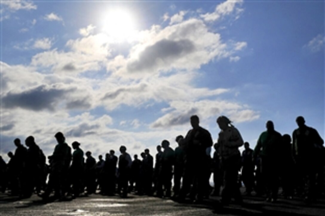 U.S. Navy Command Master Chief Bryan Exum helps clean the flight deck aboard the nuclear aircraft carrier USS Dwight D. Eisenhower during a debris walkdown in the Atlantic Ocean, Nov. 16, 2009. The Eisenhower is conducting a three-week, joint, combined composite training unit exercise off the east coast of the United States. 