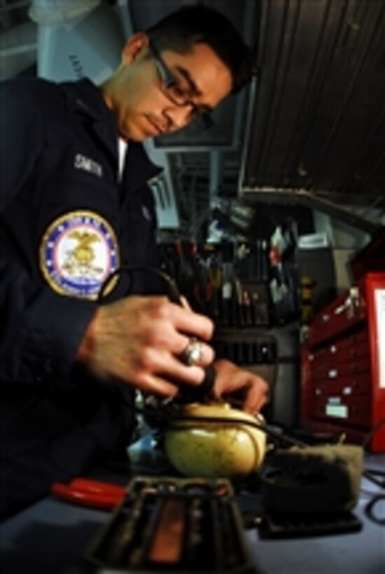 U.S. Navy Petty Officer 3rd Class Larry Smith uses a portable soldering tool to reconnect the wires on a flight deck cranial in the portable communications shop aboard the aircraft carrier USS John C. Stennis (CVN 74) in the Pacific Ocean on Nov. 15, 2009.  The Stennis and Carrier Air Wing 9 are participating in a strike group sustainment exercise off the coast of southern California.  