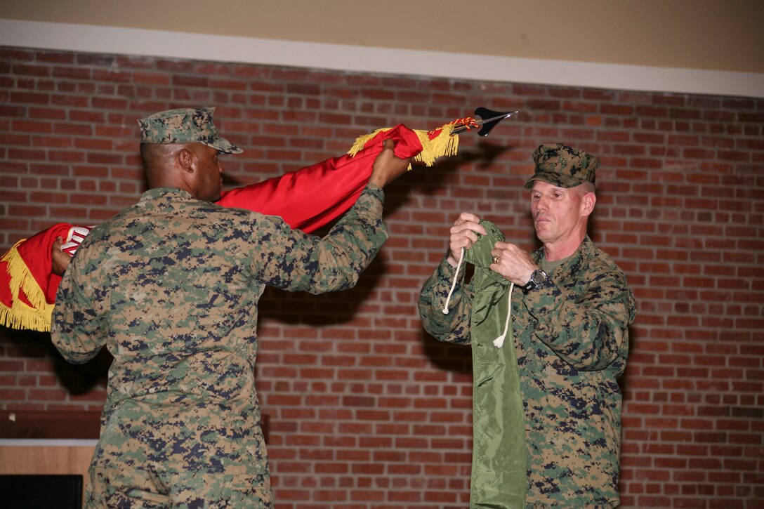 Sgt. Maj. Blaine H. Jackson, left, and Brig. Gen. Robert S. Walsh retire the 2nd Marine Aircraft Wing (Forward) colors at the unit’s deactivation ceremony, Nov. 19, at the air station theater. The unit returned in November from combat operations, supporting Operation Iraqi Freedom.