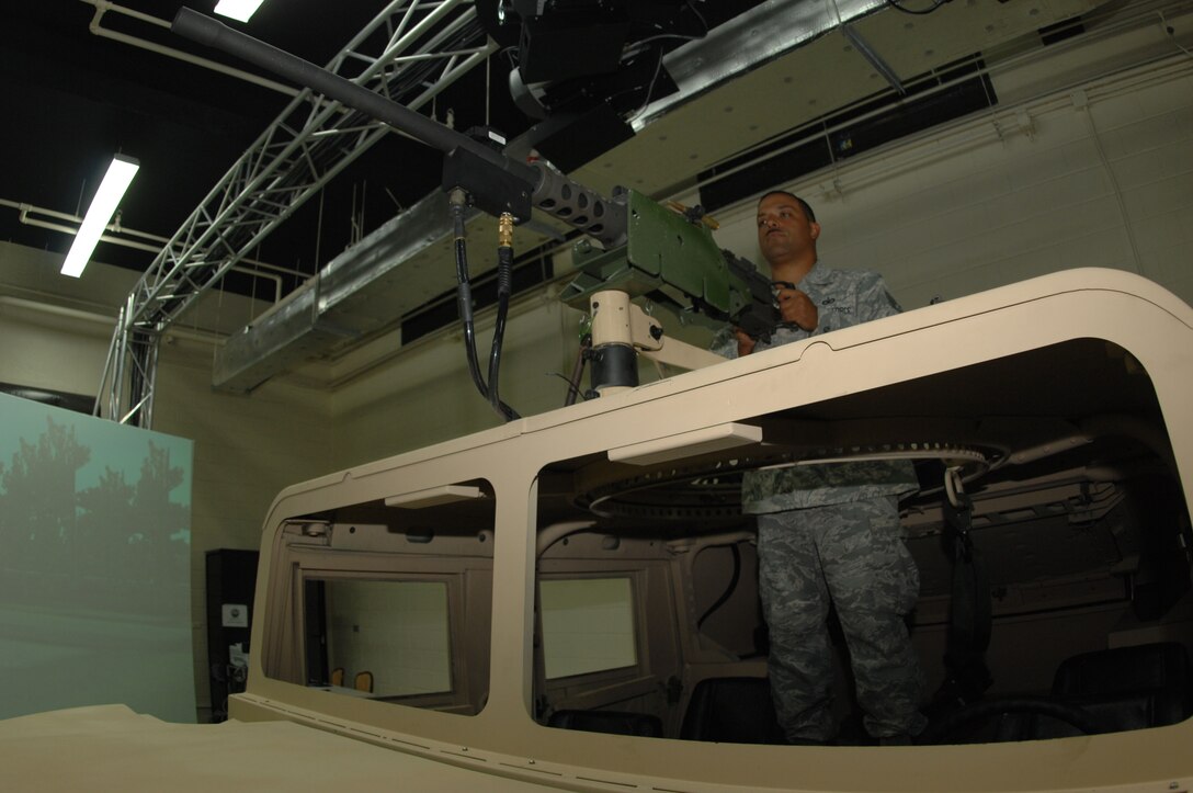 ANDERSEN AIR FORCE BASE, Guam - Tech. Sgt. Mark Gandy, 736th Security Forces Squadron program manager for the Warrior Skills Trainer, performs a function check on a replica M2 Browning heavy machine gun at the WST Nov. 19 here. Weapons like the heavy machine gun are used to combat simulated enemies programmed into the scenarios created by instruction using the WST. (U.S. Air Force photo by Senior Airman Shane Dunaway)