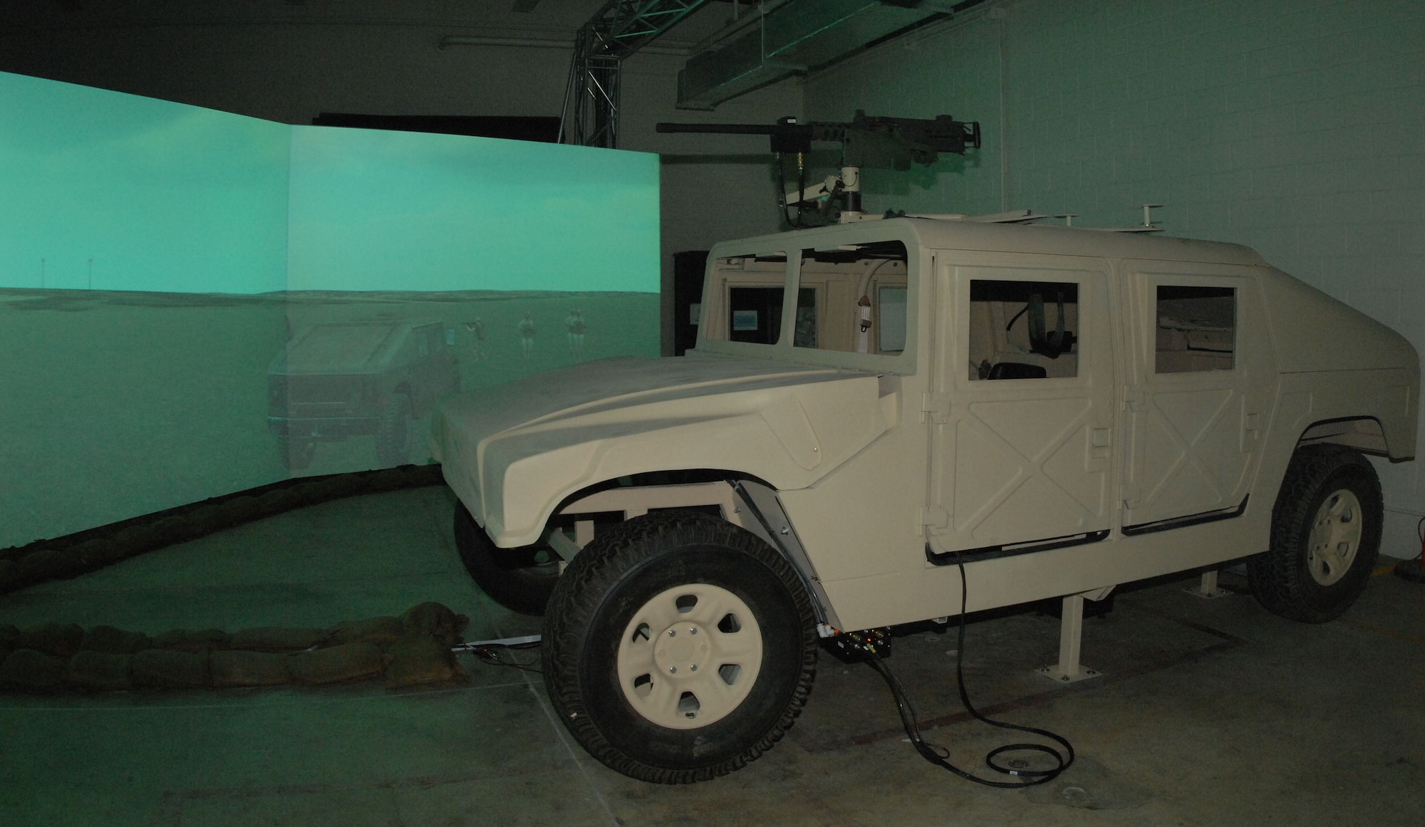 ANDERSEN AIR FORCE BASE, Guam - The Warrior Skills Trainer pictured showcases a 180-degree projection screen and full-size, computerized High Mobility Multipurpose Wheeled Vehicle, also known as HMMWV or more commonly called a humvee. Andersen AFB is the third base in the U.S. Air Force to acquire the WST. (U.S. Air Force photo by Senior Airman Shane Dunaway)