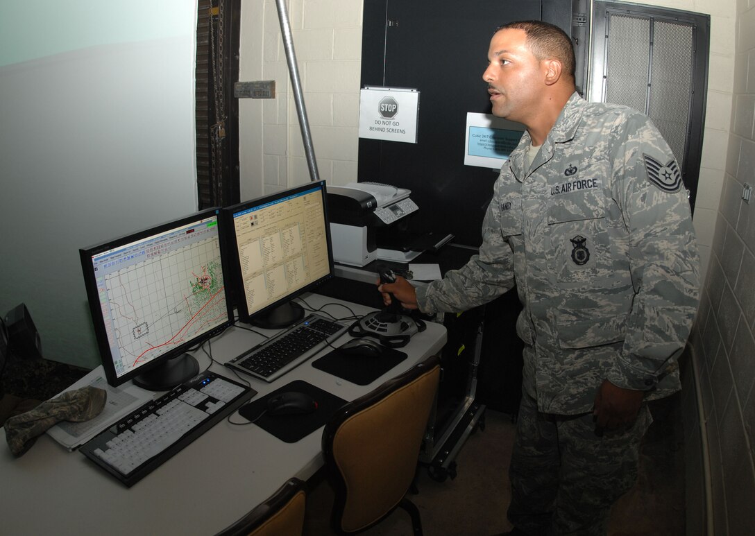 ANDERSEN AIR FORCE BASE, Guam - Tech. Sgt. Mark Gandy, 736th Security Forces Squadron program manager for the Warrior Skills Trainer, uses a joystick to perform operations within the simulator Nov. 19 here. Instructors can use the simulator to assess an individual?s knowledge and readiness in a given scenario. (U.S. Air Force photo by Senior Airman Shane Dunaway)