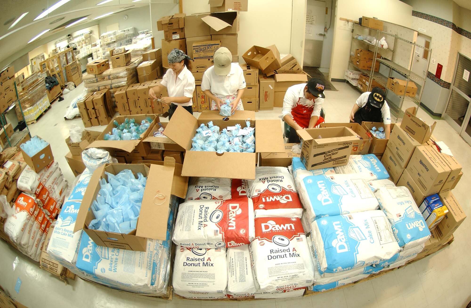 From left to right: Michi Maehara, Aona Higa, Yoshiyasu Kamiya, and Shiori Ganeko, students from Nikkei Business School, package cookies for service members living in the dorms at Kadena Air Base, Nov. 18. The Hometown Kadena Cookie Drive volunteers prepared more than 24,000 cookies that will be delivered Dec. 14 by First Sergeants and other representatives to dorm residents. "It's our way of giving them a little taste of home," said Mrs. Sheri Fletcher.  (U.S. Air Force photo/Tech. Sgt. Rey Ramon) 


