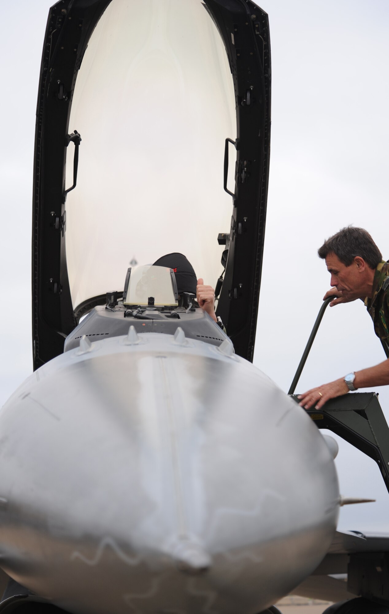 Barksdale AFB, La. - Capt. Matthew, 322d Squadron, F-16 pilot from Leeuwarden Air Base, gives a thumbs up to Sgt. 1st Class John Kraaihamp, 312d Squadron maintainer from Volkel Air Base as they do their routine checks before taxing out to the runway Nov. 16. Green Flag East is Air Combat Command’s premier close-air-support exercise. (U.S. Air Force photo by Senior Airman Alexandra M. Longfellow) (RELEASED)