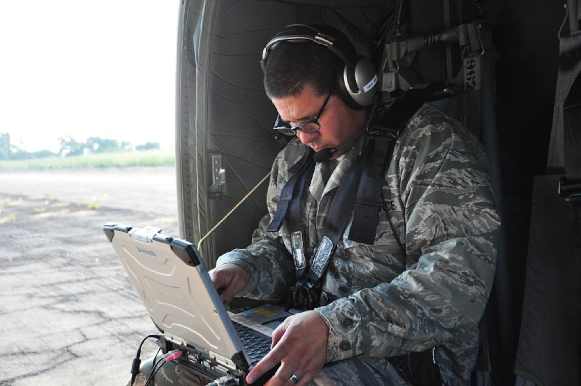 ILOPANGO, El Salvador--Air Force Maj. Leonel Gonzalez, U.S. SOUTHCOM Standing Joint Force Headquarters  Logistics Planner, operates an Automated Route Reconnaissance Kit during a Joint Task Force-Bravo helicopter flight over flood-damged El Salvador Nov. 16. The ARRK, developed by the USACE’s Engineering Research and Development Center, is an easy-to-use system that provides a safe, quick way to gather and process data. A combined U.S., Salvadoran assessment team is working together to collect data from damage sites and recommend steps to help El Salvador recover from recent floods and landslides. (U.S. Air Force photo/1st Lt. Jen Richard)