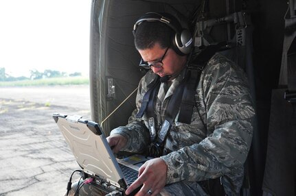 ILOPANGO, El Salvador--Air Force Maj. Leonel Gonzalez, U.S. SOUTHCOM Standing Joint Force Headquarters  Logistics Planner, operates an Automated Route Reconnaissance Kit during a Joint Task Force-Bravo helicopter flight over flood-damged El Salvador Nov. 16. The ARRK, developed by the USACE’s Engineering Research and Development Center, is an easy-to-use system that provides a safe, quick way to gather and process data. A combined U.S., Salvadoran assessment team is working together to collect data from damage sites and recommend steps to help El Salvador recover from recent floods and landslides. (U.S. Air Force photo/1st Lt. Jen Richard)