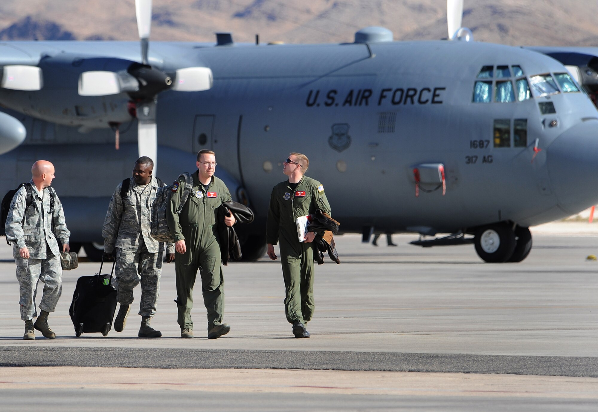 NELLIS AIR FORCE BASE, Nev.-- Air crew members assigned to the 314 Airlift Group, Dyess Air Force Base, Texas, call it a day after participating in Mobility Air Forces Exercise Nov. 18. Approximately 40 C-17s and C-130s from Air Force bases around the world flew approximately 400 Soldiers from Fort Bragg, N.C., for airdrops on the Nevada Test and Training Range. In addition to providing airdrop training, the exercise also allows soldiers the opportunity to utilize the range facilities to conduct urban ground operations training.
(U.S. Air Force photo by Lawrence Crespo)
