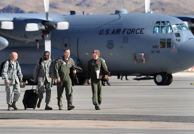 NELLIS AIR FORCE BASE, Nev.-- Air crew members assigned to the 314 Airlift Group, Dyess Air Force Base, Texas, call it a day after participating in Mobility Air Forces Exercise Nov. 18. Approximately 40 C-17s and C-130s from Air Force bases around the world flew approximately 400 Soldiers from Fort Bragg, N.C., for airdrops on the Nevada Test and Training Range. In addition to providing airdrop training, the exercise also allows soldiers the opportunity to utilize the range facilities to conduct urban ground operations training.
(U.S. Air Force photo by Lawrence Crespo)
