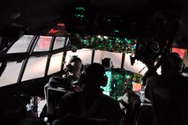 RAMSTEIN AIR BASE, Germany -- The Air Force Reserve aircrew of a C-130H Hercules tactical cargo transport aircraft assigned to the 910th Airlift Wing, based at Youngstown Air Reserve Station, Ohio, look through the cockpit windows as they land their aircraft on the runway here, October 25, 2009. A total of nine Citizen Airmen, consisting of the aircraft commander, co-pilot, flight engineer, navigator, two loadmasters, two crew chiefs and a public affairs photojournalist, traveled aboard the C-130 to Naples, Italy to transport 29 personnel from the Naples Naval Air Station to Ben Gurion Airport in Tel Aviv, Israel. Once on the ground in Tel Aviv, the crew off loaded the passengers and baggage. Within one hour of landing, the crew then reconfigured the C-130 to handle four single pallets and one double pallet of cargo, weighing approximately 14,000 pounds. After the cargo was loaded, the C-130 took off and returned here to Ramstein. The crew completing this airlift mission are among more than 70 servicemembers from YARS attached to the 38th Expeditionary Airlift Squadron, based here. The 38th EAS is supporting Operation Joint Enterprise by providing tactical airlift capability to locations in the U.S. Europe Command (EUROCOM), U.S. Africa Command (AFRICOM) and U.S. Central Command (CENTCOM) theaters of operations. U.S. Air Force photo by Master Sgt. Bob Barko Jr.    
