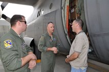 TEL AVIV, Israel -- Air Force Resere Capt. Brian Hodor (center), a pilot assigned to the 757th Airlift Squadron based at Youngstown Air Reserve Station, Ohio, talks with a representative handling the unloading of passengers and loading of cargo for airlift aboard a C-130H Hercules tactical cargo transport aircraft at Ben Gurion Airport here, October 25, 2009. Tech. Sgt. Mike Price (left), a flight engineer also assigned at YARS listens to the conversation. Capt. Hodor, Sergeant Price and the seven other Citizen Airmen from YARS delivered 29 passengers and their baggage from Naples Naval Air Station, Italy to Tel Aviv and are preparing to haul more than 14,000 pounds of cargo from Tel Aviv to Ramstein Air Base, Germany. The aircrew members completing this airlift mission are among more than 70 Servicemembers from YARS attached to the 38th Expeditionary Airlift Squadron, based at Ramstein. The 38th EAS is supporting Operation Joint Enterprise by providing tactical airlift capability to locations in the U.S. Europe Command (EUROCOM), U.S. Africa Command (AFRICOM) and U.S. Central Command (CENTCOM) theaters of operations. U.S. Air Force photo by Master Sgt. Bob Barko Jr.