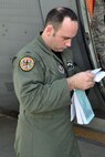 TEL AVIV, Israel -- Air Force Reserve 1st Lt. Ryan Gray, a pilot assigned to the 773rd Airlift Squadron based at Youngstown Air Reserve Station, Ohio, reviews the departure regulations for Ben Gurion Airport here, October 25, 2009. Lieutenant Gray, co-pilot on this mission, and eight other Citizen Airmen from YARS delivered 29 passengers and their baggage from Naples Naval Air Station, Italy to Tel Aviv are preparing to haul more than 14,000 pounds of cargo from Tel Aviv to Ramstein Air Base, Germany aboard the C-130H Hercules tactical cargo transport aircraft he is standing near. The aircrew members completing this airlift mission are among more than 70 Servicemembers from YARS attached to the 38th Expeditionary Airlift Squadron, based at Ramstein. The 38th EAS is supporting Operation Joint Enterprise by providing tactical airlift capability to locations in the U.S. Europe Command (EUROCOM), U.S. Africa Command (AFRICOM) and U.S. Central Command (CENTCOM) theaters of operations. U.S. Air Force photo by Master Sgt. Bob Barko Jr.