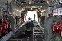 TEL AVIV, Israel -- Air Force Reservists assigned to the 910th Airlfit Wing, based at Youngstown Air Reserve Station, Ohio, work on changing the configuration of the cargo deck of a C-130H Hercules tactical cargo transport aircraft, also assigned to YARS, from carrying passengers to carrying cargo pallets, while the aircraft sits on the tarmac of Ben Gurion International Airport here, October 25, 2009. A group of nine 910th Citizen Airmen just delivered 29 passengers and their baggage to Tel Aviv on an airlift mission from Naples Naval Air Station, Italy. The 910th Airmen are scheduled to pick up four single pallets and a double pallet of cargo here and deliver them to Ramstein Air Base, Germany. It took the 910th Airmen about one hour to take out the passenger seating and install the cargo pallet rollers as well as stow all of the extra cargo deck components. The aircrew members completing this airlift mission are among more than 70 Servicemembers from YARS attached to the 38th Expeditionary Airlift Squadron, based at Ramstein. The 38th EAS is supporting Operation Joint Enterprise by providing tactical airlift capability to locations in the U.S. Europe Command (EUROCOM), U.S. Africa Command (AFRICOM) and U.S. Central Command (CENTCOM) theaters of operations. U.S. Air Force photo by Master Sgt. Bob Barko Jr.