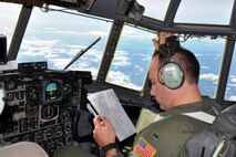 SOMEWHERE OVER NORTHERN ITALY -- Air Force Reserve pilot 1st Lt. Ryan Gray studies a navigation chart as he sits in the co-pliot chair on the flight deck of a C-130H Hercules tactical cargo transport aircraft assigned to the 910th Airlift Wing, based at Youngstown Air Reserve Station, Ohio. Lieutenant Gray and eight other Citizen Airmen from YARS are flying to Naples Naval Air Station, Italy to pick up 29 passengers and their baggage and deliver them to Ben Gurion Airport in Tel Aviv, Israel. The Italian coastline on the Ligurian Sea can be seen in the dictance out of the C-130's cockpit windows. The aircrew members flying on this airlift mission are among more than 70 Servicemembers from YARS attached to the 38th Expeditionary Airlift Squadron, based at Ramstein. The 38th EAS is supporting Operation Joint Enterprise by providing tactical airlift capability to locations in the U.S. Europe Command (EUROCOM), U.S. Africa Command (AFRICOM) and U.S. Central Command (CENTCOM) theaters of operations. U.S. Air Force photo by Master Sgt. Bob Barko Jr. 