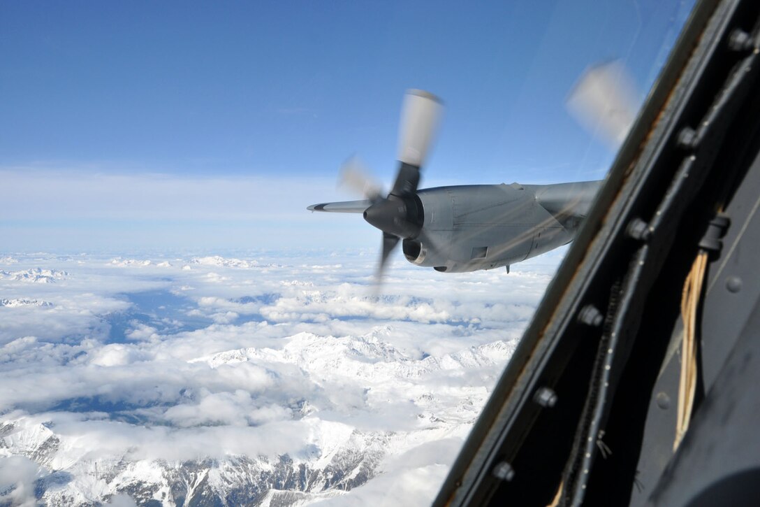 SOMEWHERE OVER AUSTRIA -- An Air Force Reserve C-130H Hercules tactical cargo transport aircraft assigned to the 910th Airlift Wing, based at Youngstown Air Reserve Station, Ohio flies over the Austrian Alpine mountains during an airlift mission to Naples, Italy, October 24, 2009. A crew of nine Citizen Airmen from the 910th are flying to the Naval Air Station in Naples to pick up 29 passengers and their baggage and deliver them to Ben Gurion Airport in Tel Aviv, Israel. The aircrew members flying on this airlift mission are among more than 70 Servicemembers from YARS attached to the 38th Expeditionary Airlift Squadron, based at Ramstein. The 38th EAS is supporting Operation Joint Enterprise by providing tactical airlift capability to locations in the U.S. Europe Command (EUROCOM), U.S. Africa Command (AFRICOM) and U.S. Central Command (CENTCOM) theaters of operations. U.S. Air Force photo by Master Sgt. Bob Barko Jr.