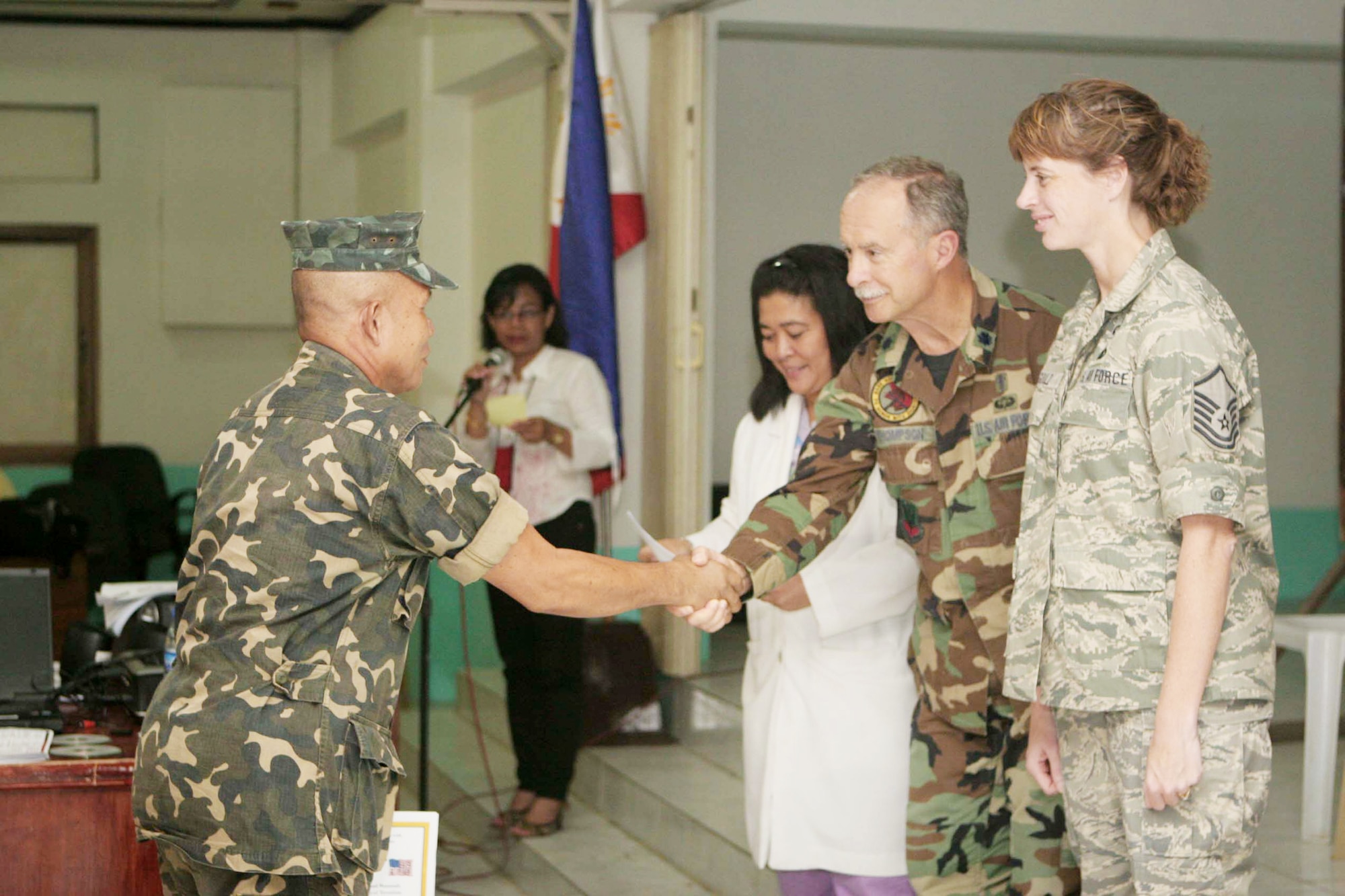 Joint Special Operations Task Force-Philippines Chaplain Col. Steven Thompson hands out a graduation certificate to an attendee at a three-day psychosocial combat stress class taught Nov. 18, 2009, at Camp Navarro General Hospital at Western Mindanao Command in Zamboanga, Philippines. Taught jointly by the hospital's psychologist and members of the JSOTF-P Command chaplain teams, the class focused on treatments for victims of wars and man-made disasters. (U.S. Marine Corps photo/Sgt. Jose Castellonlopez)
