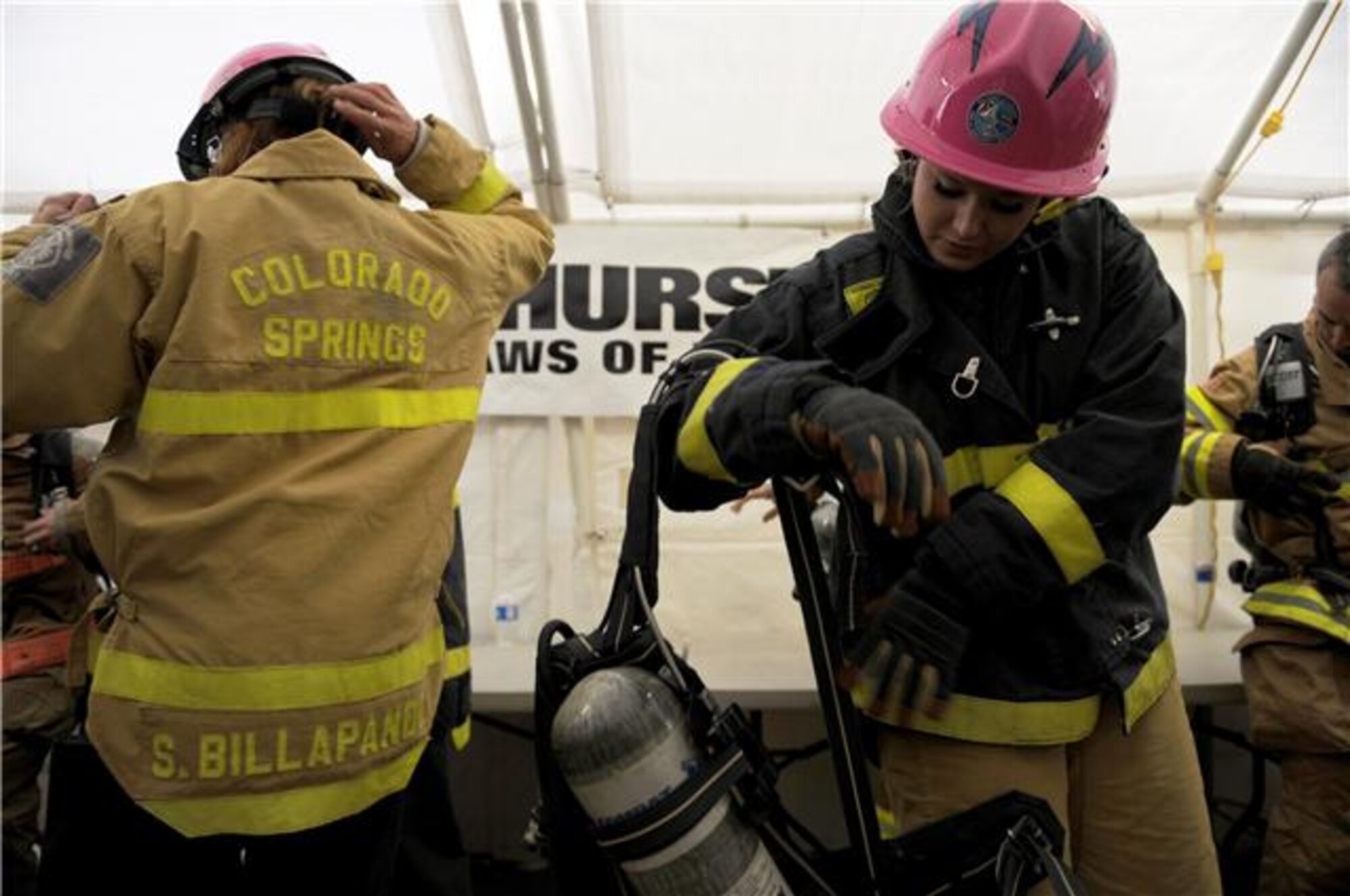 Airman 1st Class Jessica Morehouse puts on gear before she competes in the team relay event Nov. 18, 2009 at the Scott Firefighter Combat Challenge in Las Vegas. Airman Morehouse is assigned to the Air Force Academy, Colorado Springs, Colo. (U.S. Air Force photo/Staff Sgt. Desiree N. Palacios)