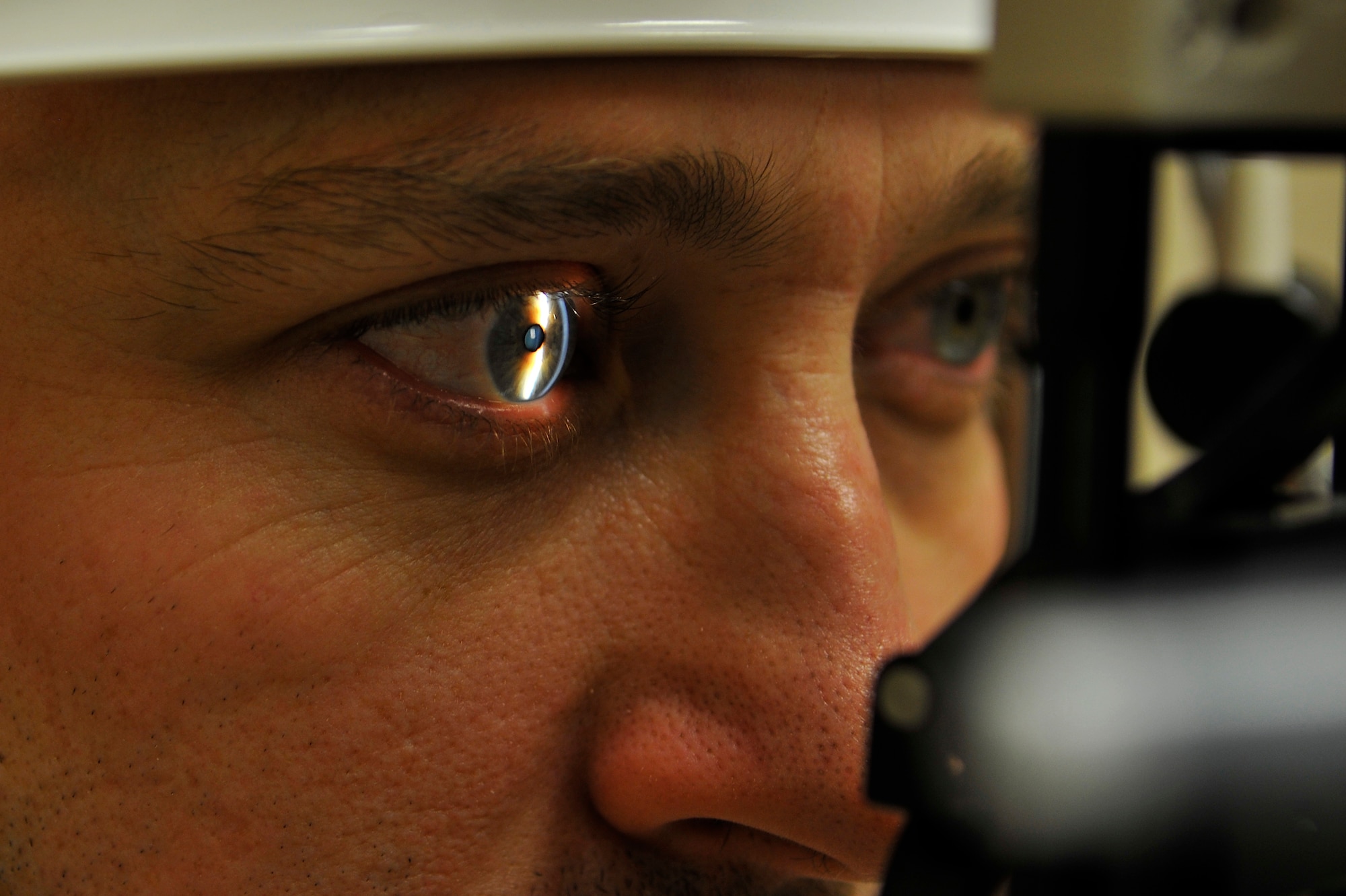 Capt. Luanne Danes uses a light to check the anterior segment of Master Sgt.
Timothy Vanderhoff's eye during his visit to the Optometry Clinic Nov. 19,
2009, Eielson Air Force Base, Alaska. Captain Danes is looking for healthy
structure of the eye and ensuring no corneal disease is present. Captain
Danes, officer in charge of Optometry, is assigned to the 354th Medical
Operation Squadron. Sergeant Vanderhoff, crew chief, is assigned to the
168th Aircraft Maintenance Squadron. (U.S. Air Force photo/Staff Sgt.
Christopher Boitz)
