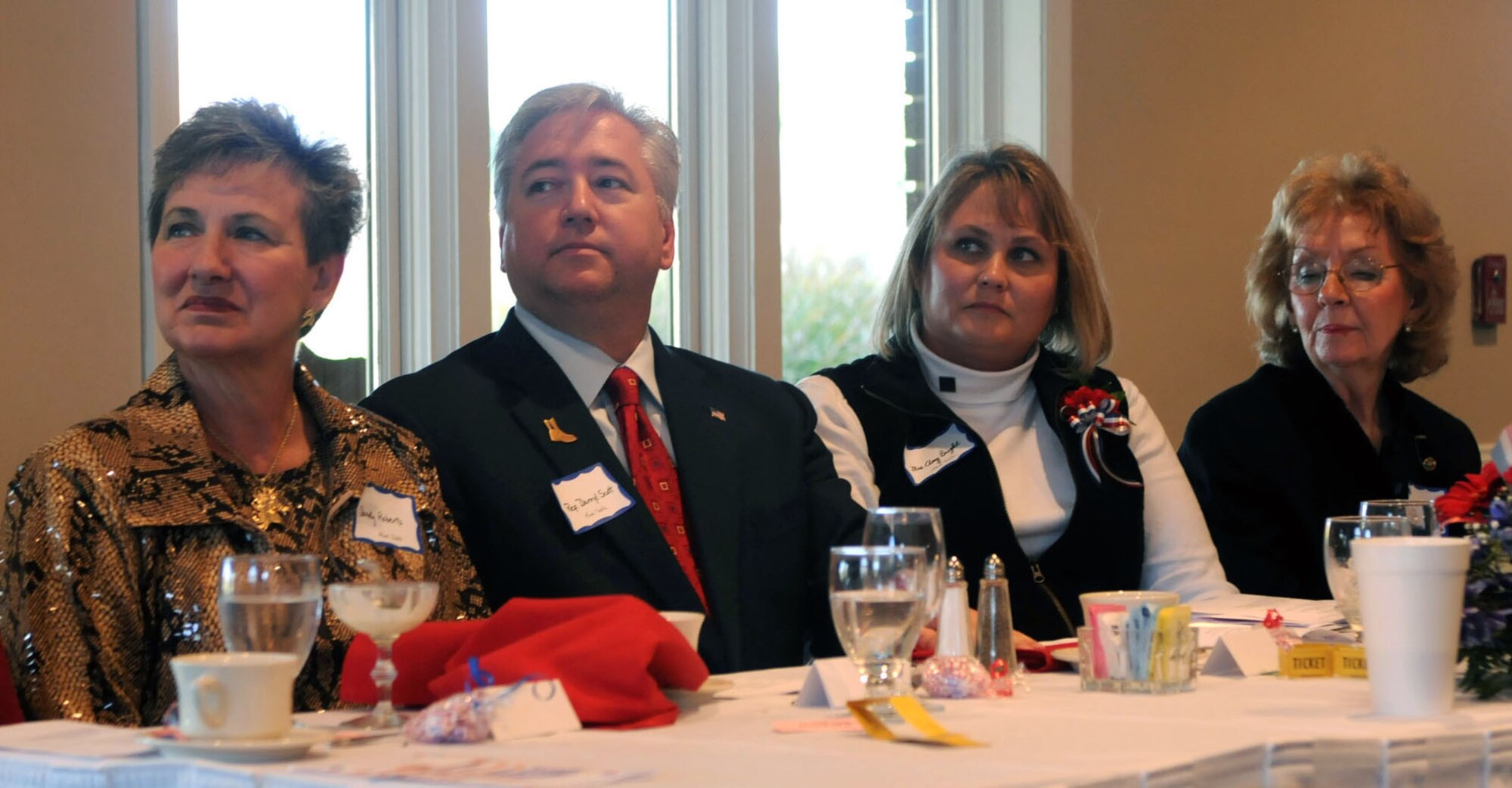 From right to left, Mary Emma Tisinger, Dover Century Club president, Amy Bright, spouse of 512th Airlift Wing Commander Col. Randal L. Bright, Delaware State Senator Darryl Scott, and Sandy Roberts, Delaware State Federation of Women's Clubs president elect, were some of the more than 90 people who attended the Dover Century Club luncheon Nov. 18 at the Maple Dale Country Club. Mrs. Bright was the guest speaker at the event, themed ?Hats Off to Military Spouses.? (U.S. Air Force photo/Capt. Marnee A.C. Losurdo)