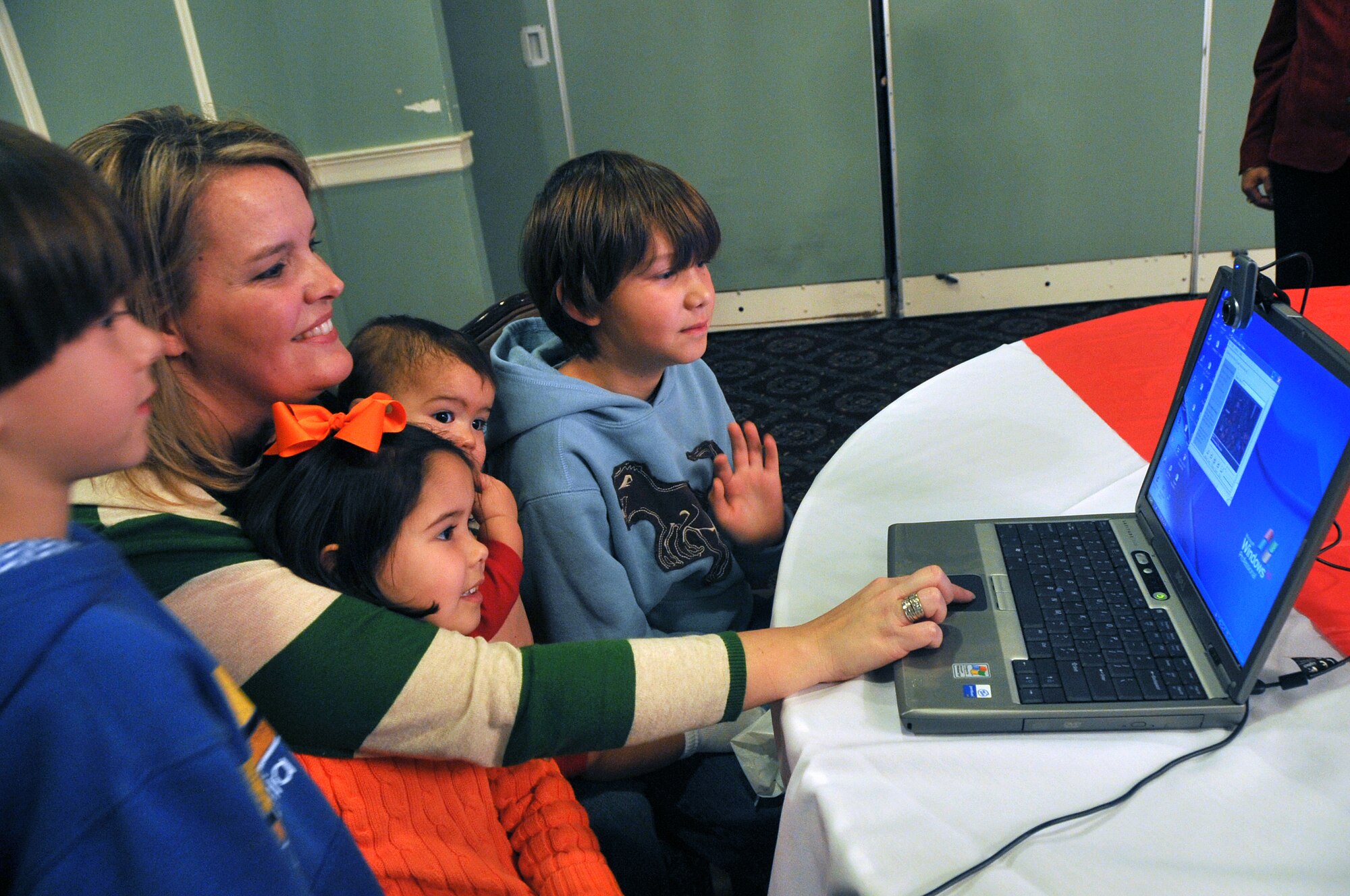OFFUTT AIR FORCE BASE, Neb. - Alice Rehome, wife of Maj. Paul Rehome, sits with her children Brycen, Briggs, Lei La-Anne and Taggert while recording a video message during Holiday Connections Nov. 17 in the Patriot Club. The event, established in 2000, provides support for the loved ones of military members deployed during the holiday season. U.S. Air Force photo by Jeff W. Gates