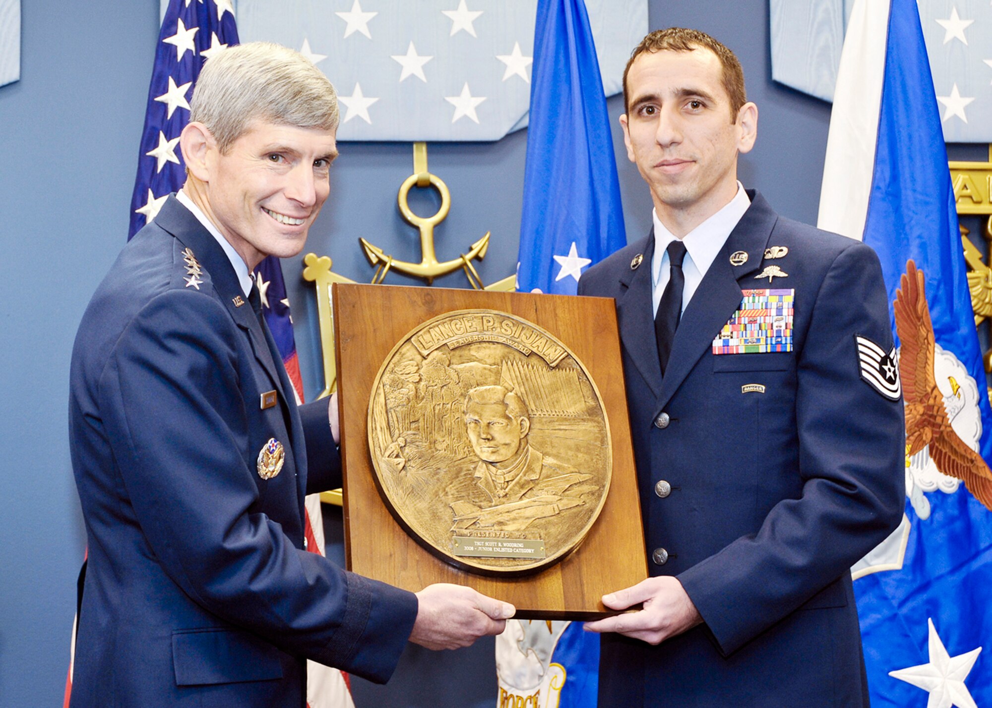Air Force Chief of Staff Gen. Norton Schwartz presents the Capt. Lance P Sijan Air Force Leadership Award to Tech. Sgt. Scott Woodring Nov. 18, 2009.  The Sijan Award recognizes the accomplishments of officer and enlisted Airmen who have demonstrated the highest qualities of leadership in the performance of their duties and the conduct of their lives. (U.S. Air Force photo/Michael J Pausic)