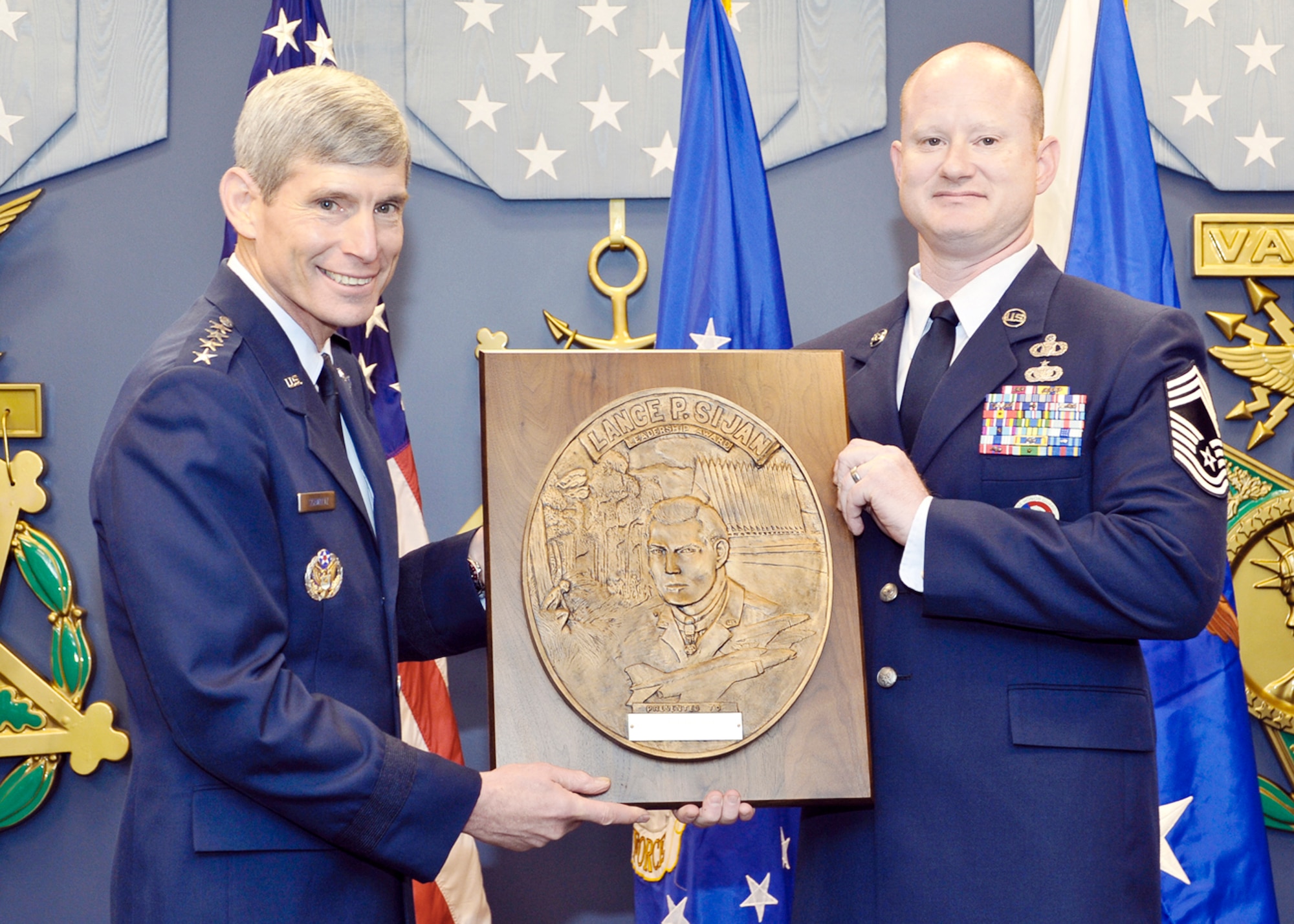 Air Force Chief of Staff Gen. Norton Schwartz presents the Capt. Lance P Sijan Air Force Leadership Award to Chief Master Sgt. Michael Bobbitt Nov. 18, 2009.  The Sijan Award recognizes the accomplishments of officer and enlisted Airmen who have demonstrated the highest qualities of leadership in the performance of their duties and the conduct of their lives. (U.S. Air Force photo/Michael J Pausic)