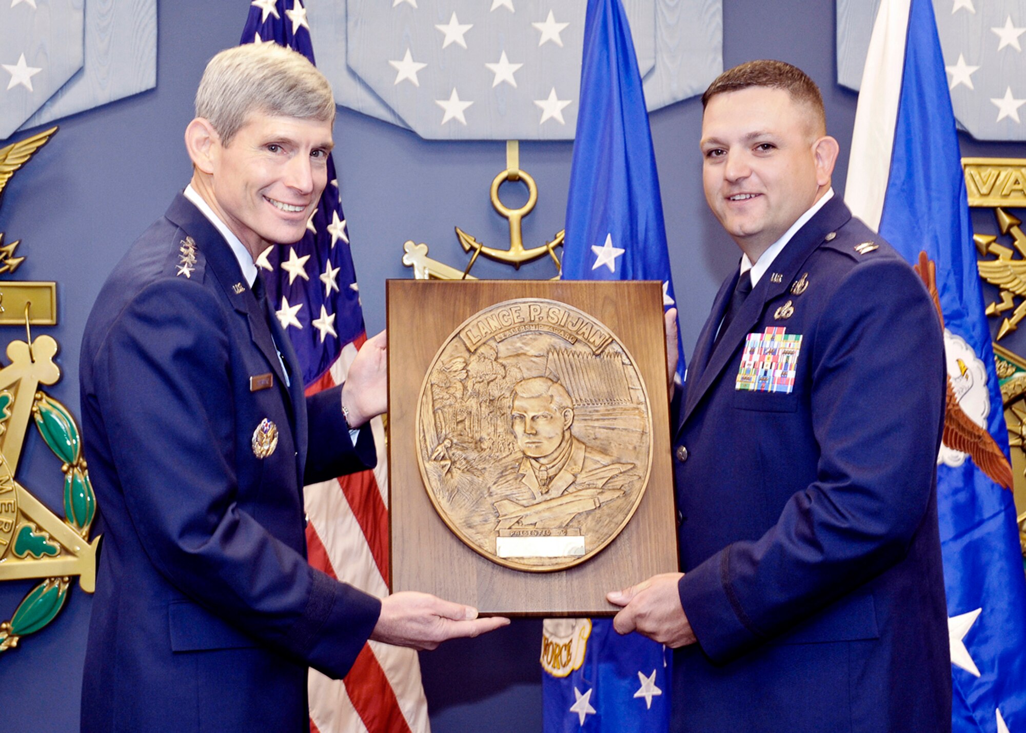 Air Force Chief of Staff Gen. Norton Schwartz presents the Capt. Lance P Sijan Air Force Leadership Award to Capt. Thomas Eckel Nov. 18, 2009.  The Sijan Award recognizes the accomplishments of officer and enlisted Airmen who have demonstrated the highest qualities of leadership in the performance of their duties and the conduct of their lives. (U.S. Air Force photo/Michael J Pausic)