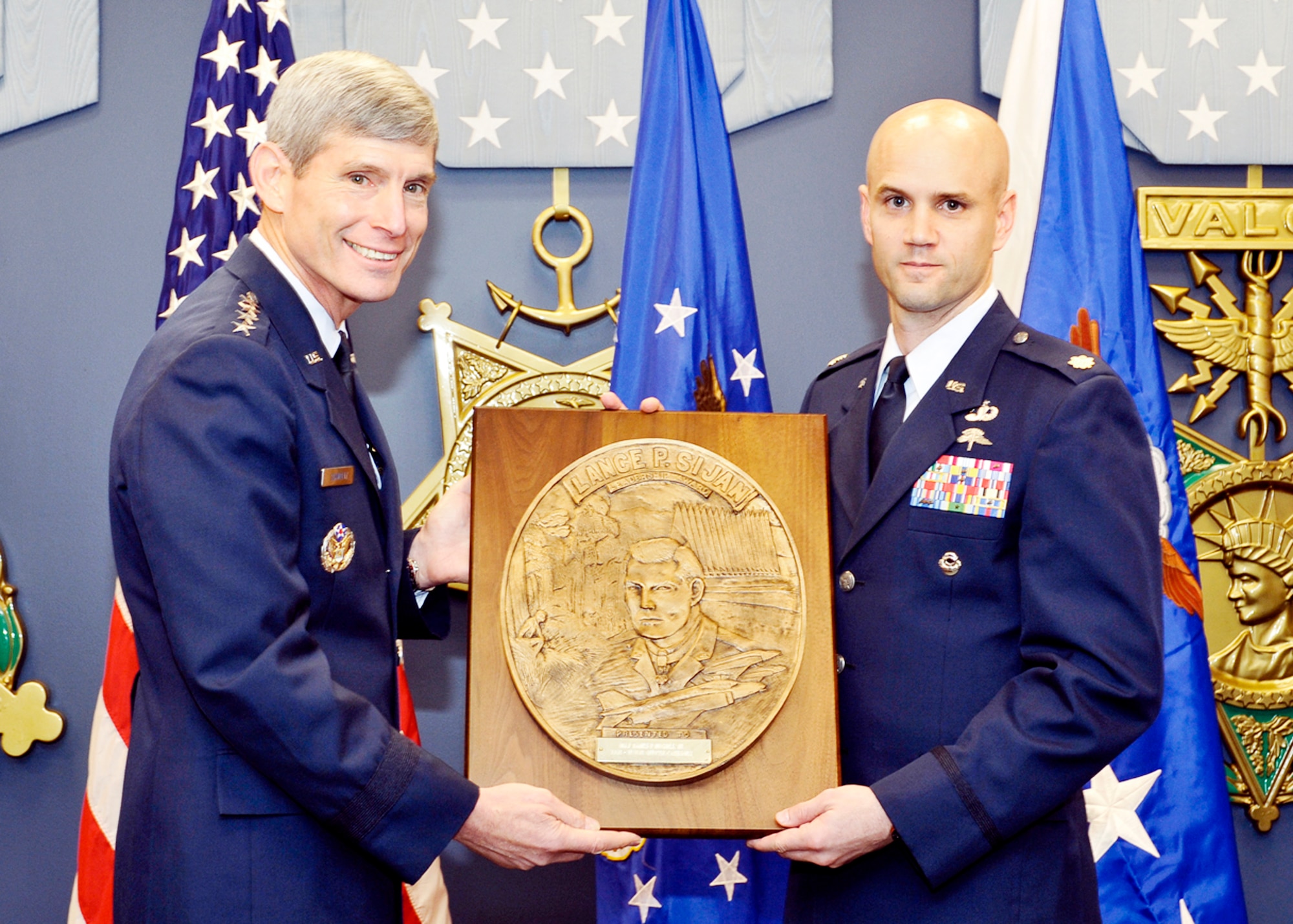 Air Force Chief of Staff Gen. Norton Schwartz presents the Capt. Lance P Sijan Air Force Leadership Award to Maj. James Hughes Jr., Nov. 18, 2009.  The Sijan Award recognizes the accomplishments of officer and enlisted Airmen who have demonstrated the highest qualities of leadership in the performance of their duties and the conduct of their lives. (U.S. Air Force photo/Michael J Pausic)