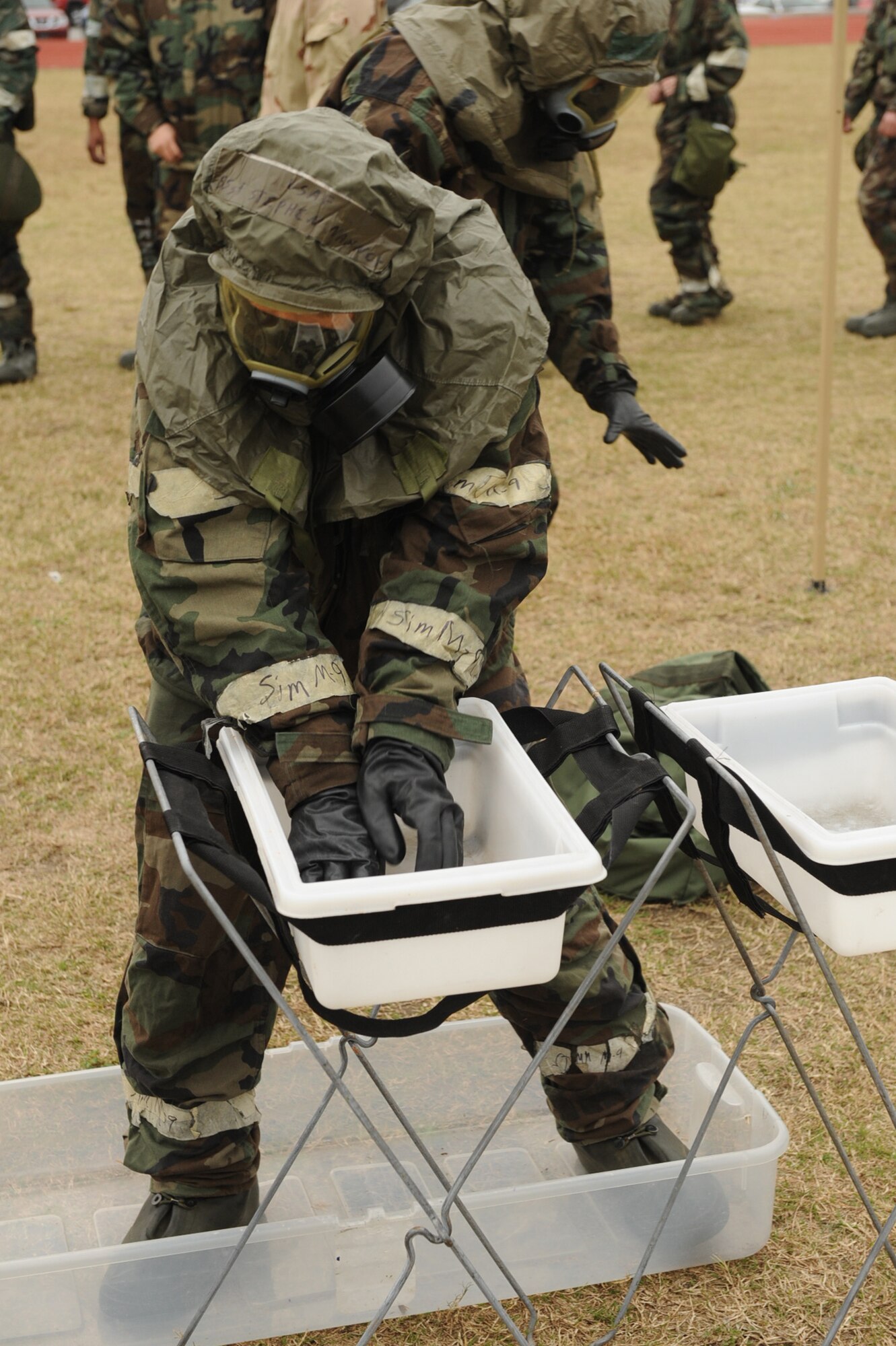Airmen 1st Class James Hare, 4th Communications Squadron records management specialist, goes through a simulated decontamination area during an ability to survive and operate training session on Seymour Johnson Air Force Base, N.C., Nov. 18, 2009. The training was held to prepare Airmen for the upcoming Phase II exercise in December. (U.S. Air Force photo/Senior Airman Ciara Wymbs) 