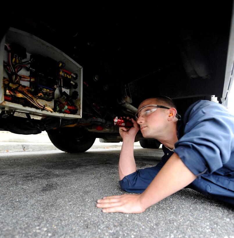 LANGLEY AIR FORCE BASE, Va. — Staff Sgt. Bradley Edris, 1st Logistics Readiness Squadron Vehicle Maintenance technician, assesses water damage to a bus Nov 19. Vehicle mechanics assessed damage to government-owned vehicles following a nor’easter that struck Langley last week. (U.S. Air Force photo/Senior Airman Dana Hill)