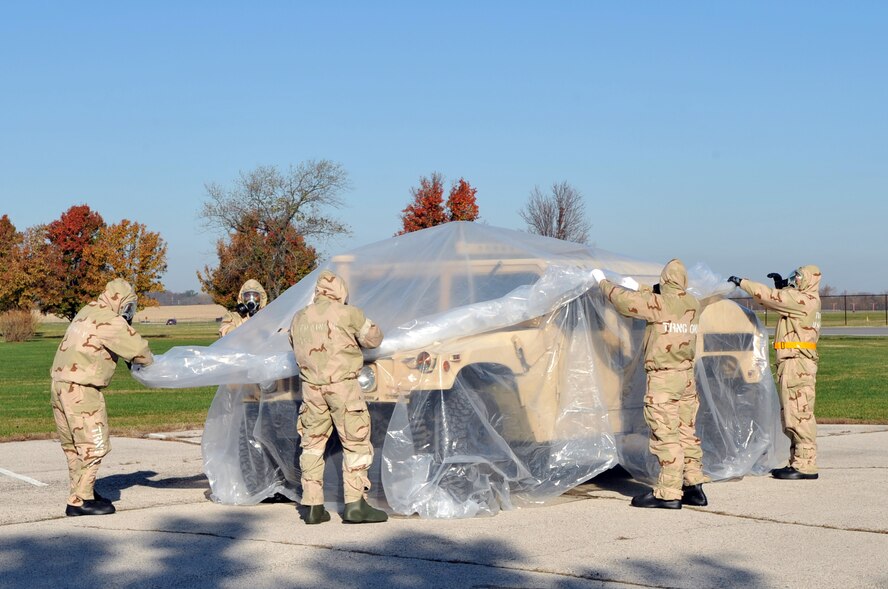 SCOTT AIR FORCE BASE, Ill -- Members of the 375th Air Mobility Wing remove the first layer of contaminated plastic from a vehicle during an Operational Readiness Inspection preparation course Nov. 5.  Members are preparing for the 375th AMW's inspection scheduled for March 2010. Members spent 70 minutes at various stations improving their skills in chemical warfare. (U.S. Air Force photo by Senior Airman Teresa Jennings) 