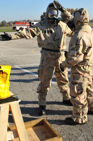 SCOTT AIR FORCE BASE, Ill -- Members of the 375th Air Mobility Wing decontemate each other with M295 Individual Equipment Decontamination Kit at a contamination control area during an Operational Readiness Inspection preparation course Nov. 5.  Members are preparing for the 375th AMW's inspection scheduled for March 2010. Members spent 70 minutes at various stations improving their skills in chemical warfare. (U.S. Air Force photo by Senior Airman Teresa Jennings) 