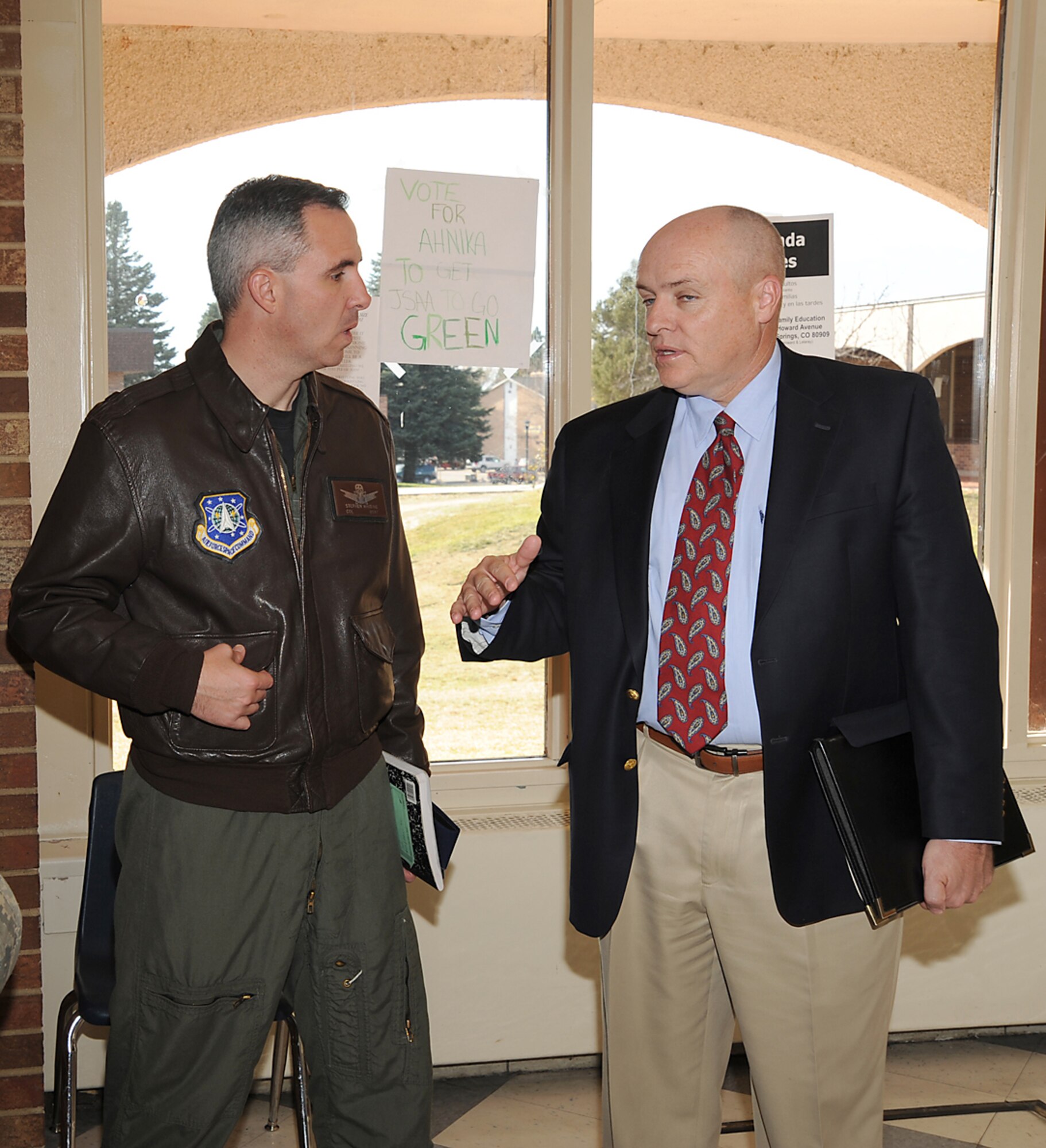 Col. Stephen Whiting, 21st Space Wing commander, speaks with Mike Poore, deputy superintendent for District 11 schools, during a tour of the new Jack Swigert Aerospace Academy Middle School Nov. 10. Middle school students living on base may attend the academy, which features a space and engineering curriculum for its students. (Air Force photo by Roberta McDonald)