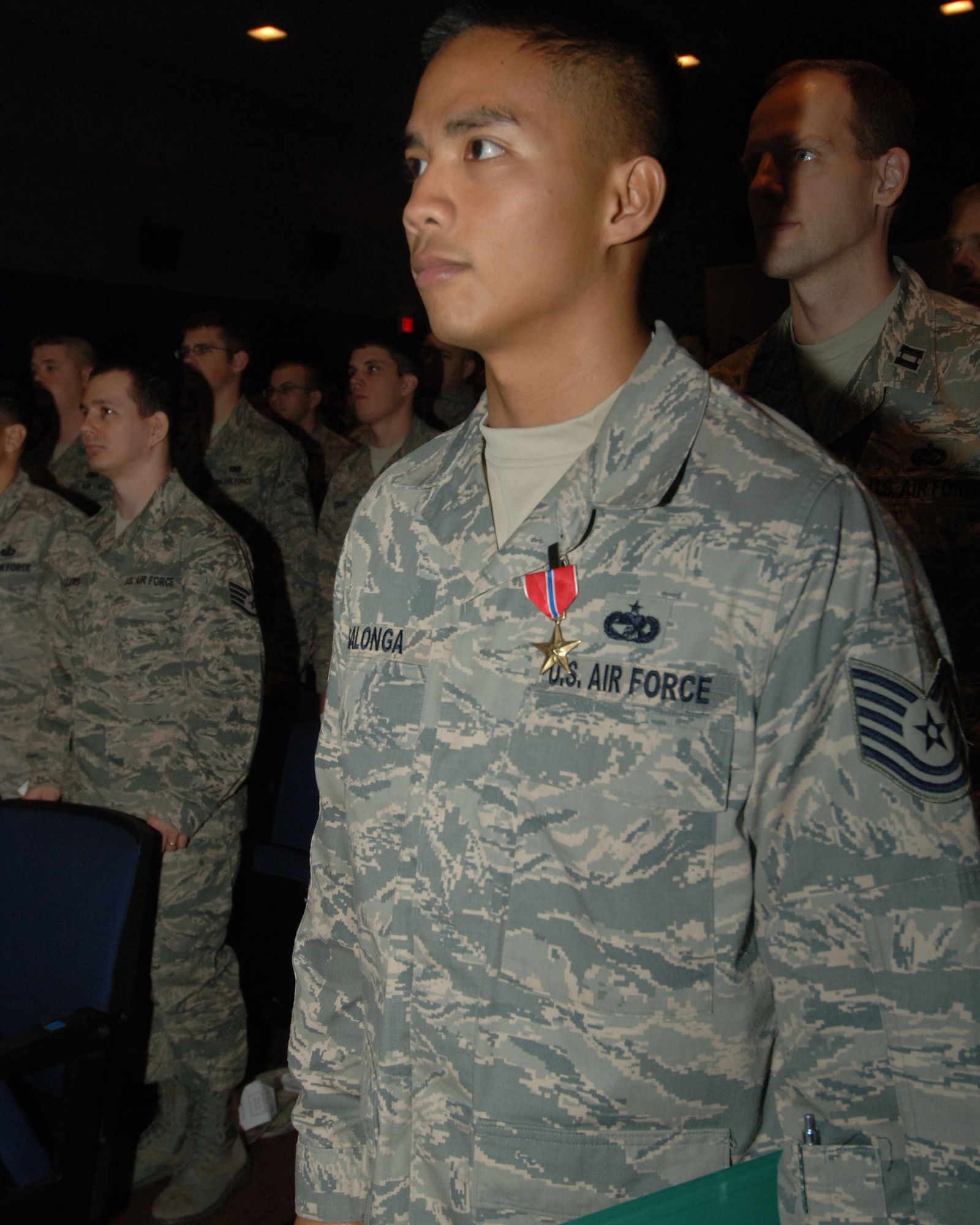 Tech. Sgt. Jeffery P. Salonga, 319th Logistics Readiness Squadron vehicle operator, stands at attention after receiving the Bronze Star during a wing commander’s call Nov. 12. The Honorable Daniel B. Ginsberg, assistant secretary of the Air Force for manpower and Reserve affairs, presented the medal to Sergeant Salonga. (U.S. Air Force photo by Senior Airman R. Michael Longoria)