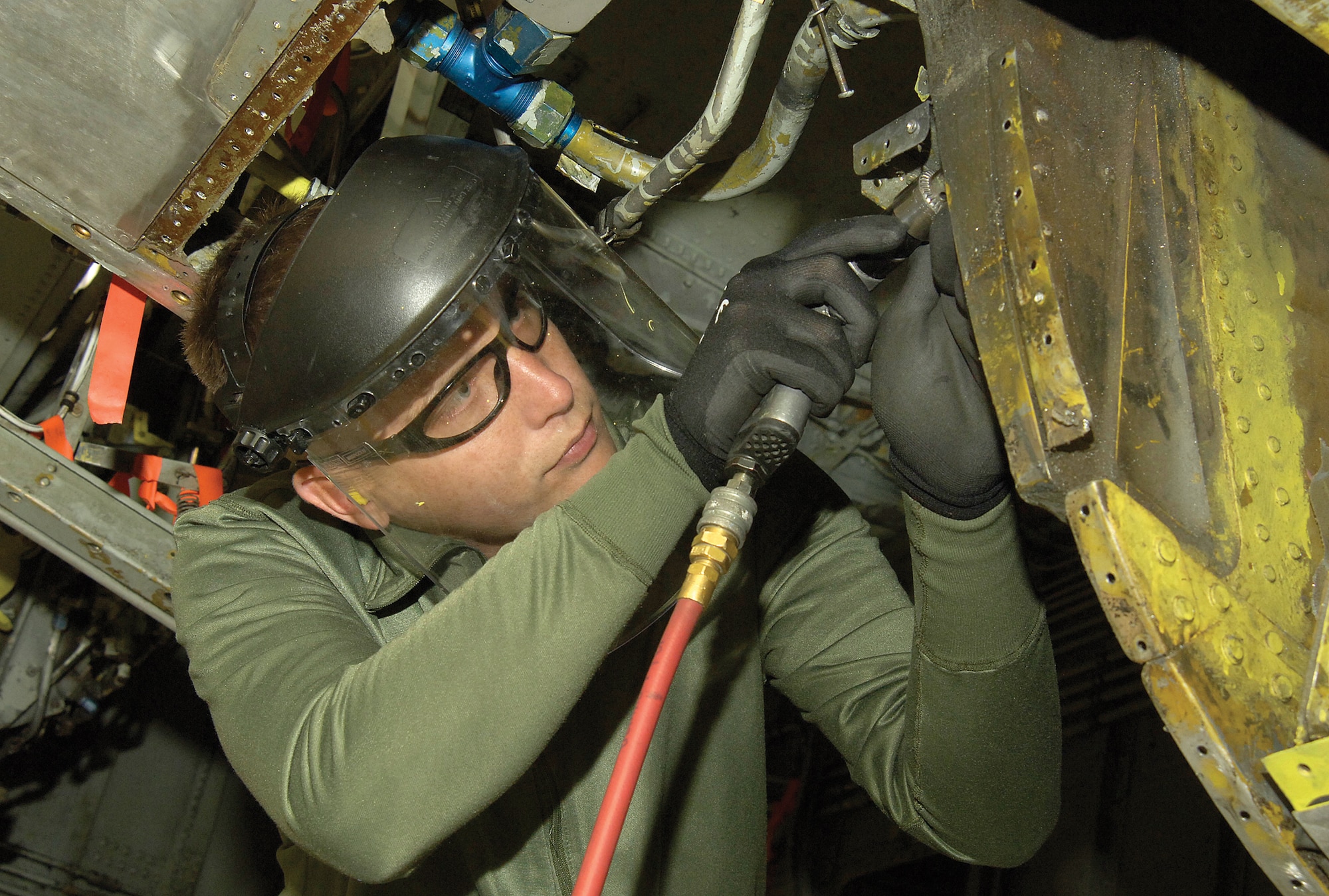 Staff Sgt. William Patterson, aircraft sheet metal mechanic with the 76th Aircraft Maintenance Group, is a member of the Expeditionary Depot Maintenance Flight and is prepared at any moment to deploy worldwide with a team to make battle-damaged aircraft flyable. When not deployed, he lends his skills to depot maintenance here at Tinker. (Air Force photo by Margo Wright) 