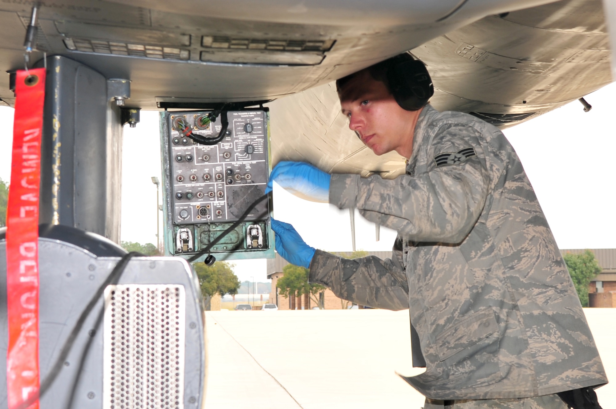 Senior Airman Phillip Butche, 4th Aircraft Maintenance Squadron specialist flight, disconnects a communication cable from an F-15 E Strike Eagle after refueling at Seymour Johnson Air Force Base, N.C., Nov. 17, 2009. The communication cable allows the Airmen on the ground to talk to the aircrew during refueling.  Airman Butche is from Indianapolis, Ind. (U.S. Air Force photo/Airman 1st Class Rae Perry)