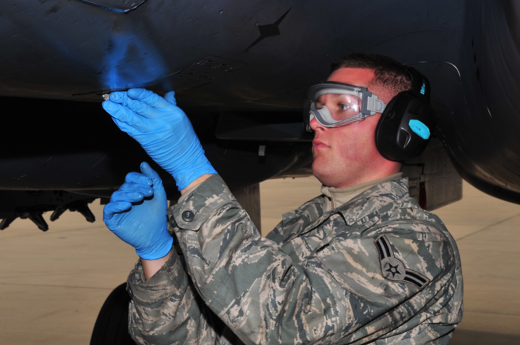 Airman 1st Class Phillip Huston, 4th Aircraft Maintenance Squadron specialist flight, opens an F-15E Strike Eagle fuel door during a hot pit at Seymour Johnson Air Force Base, N.C., Nov. 17, 2009. During a hot pit, it takes 15 minutes to pump 300 gallons of JP-8 Jet Fuel into an F-15E. Airman Huston hails from Salisbury, N.C. (U.S. Air Force photo/Airman 1st Class Rae Perry)