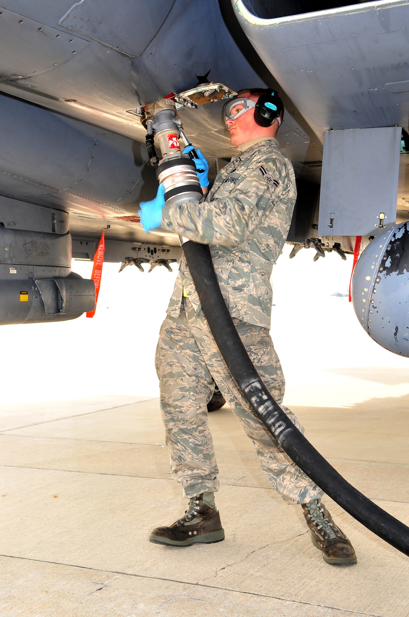 Airman 1st Class Phillip Huston, 4th Aircraft Maintenance Squadron specialist flight, connects a fuel hose to an F-15E Strike Eagle during a hot pit at Seymour Johnson Air Force Base, N.C., Nov. 17, 2009. A hot pit is when the jet lands and shuts down one engine to refuel for another sortie. Airman Huston hails from Salisbury, N.C. (U.S. Air Force photo/Airman 1st Class Rae Perry)