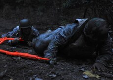 Staff Sgt. Vincent Barnes and Senior Airman Michael Rodriquez finish up the 50 meter high crawl and low crawl course during base-level Expeditionary Combat Skills Training at Charleston Air Force Base, S.C., on Nov. 17, 2009. The high crawl and low crawl teaches individuals how to move while under fire. Airman Rodriquez is a special handling journeyman and Sergeant Barnes is a ramp services specialist, both are with the 437th Aerial Port Squadron.(U.S. Air Force Photo/Senior Airman Katie Gieratz)