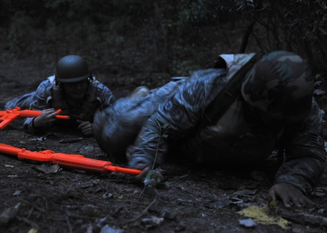 Staff Sgt. Vincent Barnes and Senior Airman Michael Rodriquez finish up the 50 meter high crawl and low craw course at Charleston AFB Nov. 17. The high crawl and low crawl teaches individuals how to move while under fire. Airman Rodriquez is a special handling journeyman and Sergeant Barnes is a ramp services specialist, both are with the 437th Aerial Port Squadron.(U.S. Air Force photo/Senior Airman Katie Gieratz)(RELEASED)