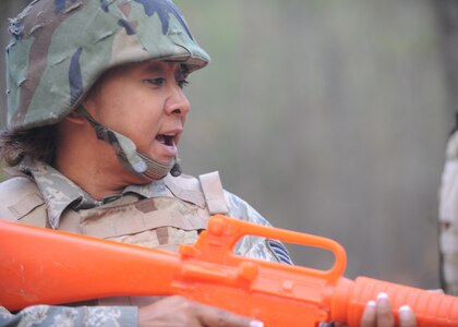 Tech. Sgt. Nonglaks Dyer responds to opposing forces during Expeditionary Combat Skills Training at Charleston AFB Nov. 17. There are typically 40 students in each class with a maximum of 55. Sergeant Dyer is a cargo documentation NCOIC with the 437th Aerial Port Squadron. (U.S. Air Force photo/Senior Airman Katie Gieratz)(RELEASED)