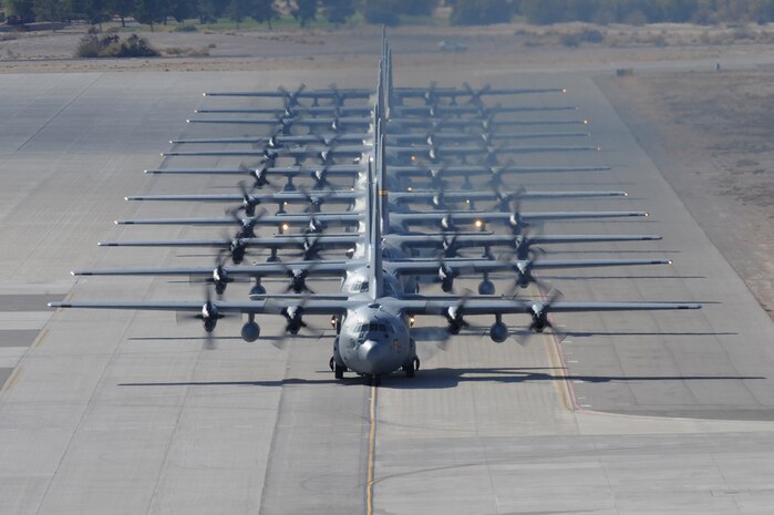 NELLIS AIR FORCE BASE, Nev.-- A row of C-130 Hercules taxi during a Mobility Air Forces Exercise on Nov. 18. The aircraft are part of the bi-annual, U.S. Air Force Weapons School MAFEX which provides realistic training for combat air force, mobility air force, and U.S. Army personnel.  Approximately 40 C-17s and C-130s from Air Force bases around the United States flew approximately 400 Soldiers from Fort Bragg, N.C., for airdrops on the Nevada Test and Training Range. In addition to providing airdrop training, the exercise also allows Soldiers the opportunity to utilize Range facilities to conduct urban ground operations training.(U.S. Air Force Photo / Airman 1st Class Stephanie Rubi)(RELEASED)