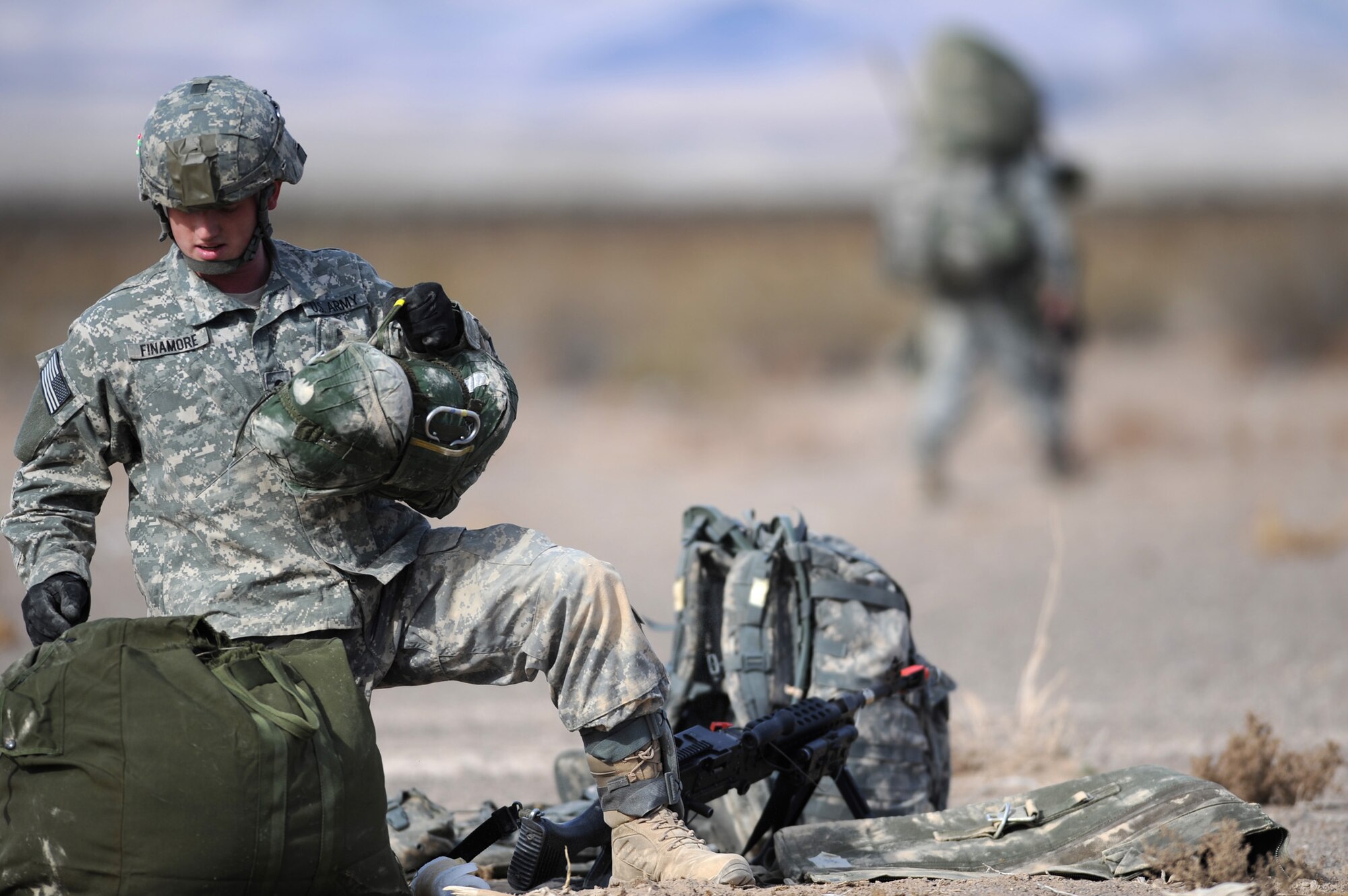 NEVADA TEST AND TRAINING RANGE -- 
Spc. Jason Finamore 173 Calvary Airborne Reconnaissance Squadron, scout from Fort Bragg, N.C., secures his reserve parachute after being airdropped into the the Urban Operations Complex in the NTTR.  The soldiers are part of the bi-annual, U.S. Air Force Weapons School Mobility Air Forces Exercise which provides realistic training for combat air force, mobility air force, and U.S. Army personnel.  Approximately 40 C-17s and C-130s from Air Force bases around the United States flew approximately 400 Soldiers from Fort Bragg, N.C., for airdrops on the Nevada Test and Training Range. In addition to providing airdrop training, the exercise also allows Soldiers the opportunity to utilize Range facilities to conduct urban ground operations training.
(U.S. Air Force photo by Tech. Sgt. Michael R. Holzworth)