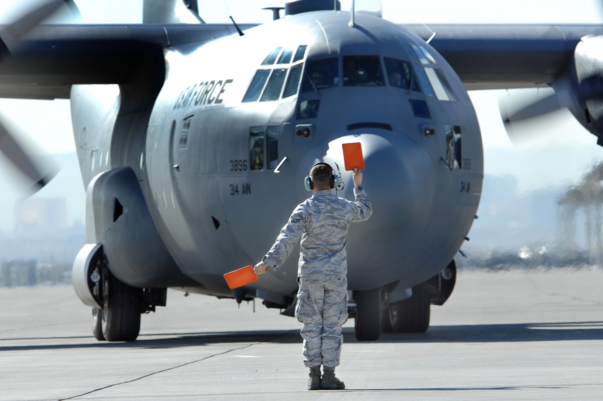 NELLIS AIR FORCE BASE, Nev. -- A crew chief assigned to the 317 Airlift Wing recovers a C-130 Hercules on the Nellis flightline during a Mobility Air Forces Exercise Nov. 18. The aircraft participated the bi-annual, U.S. Air Force Weapons School MAFEX which provides realistic training for combat air force, mobility air force, and U.S. Army personnel.  Approximately 40 C-17s and C-130s from Air Force bases around the world flew approximately 400 Soldiers from Fort Bragg, N.C., for airdrops on the Nevada Test and Training Range. In addition to providing airdrop training, the exercise also allows soldiers the opportunity to utilize Range facilities to conduct urban ground operations training.
(U.S. Air Force Photo / Mr. Lawrence Crespo)(RELEASED)

