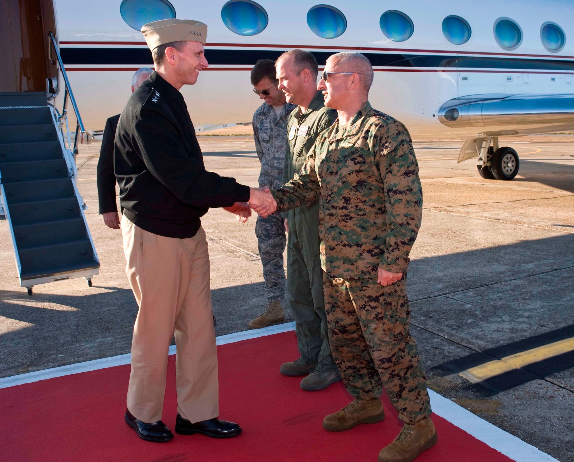 Adm. Jonathan Greenert, Vice Chief of Naval Operations, is greeted by Marine Col. Arthur Tomassetti, 33rd Fighter Wing vice commander, Col. Evan Thomas, 46th Test Wing vice commander, and Col. Bruce McClintock, 96th Air Base Wing commander, upon his arrival here. The flag officer, who is the second highest in the Navy's military leadership, visited personnel at their service-sponsored training center for military Explosive Ordinance Disposal technicians and future F-35 Joint Strike Fighter operations site here. Additionally Admiral Greenert received briefings on the Air Armament Center and a variety of other Eglin missions during his short stop between visiting nearby Navy installations on the Emerald Coast. (U.S. AIr Force photo/Bruce Hoffman)