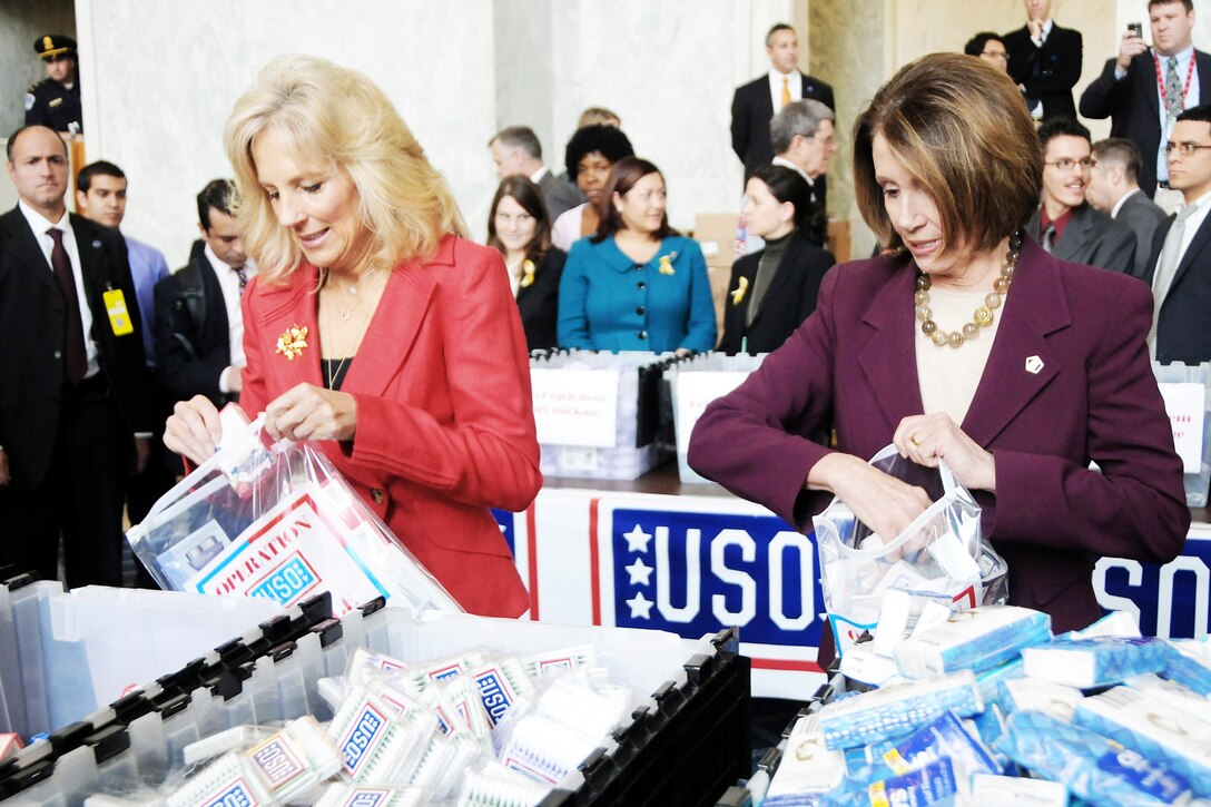 Dr. Jill Biden, wife of Vice President Joe Biden, and Speaker of the House Nancy Pelosi participated in a USO-sponsored event to build some 2,000 care packages that contain items specifically for female servicemembers Nov. 18, 2009, on Capitol Hill. This is the first time the USO has targeted care packages specifically to servicewomen. (U.S. Army photo/C. Todd Lopez)